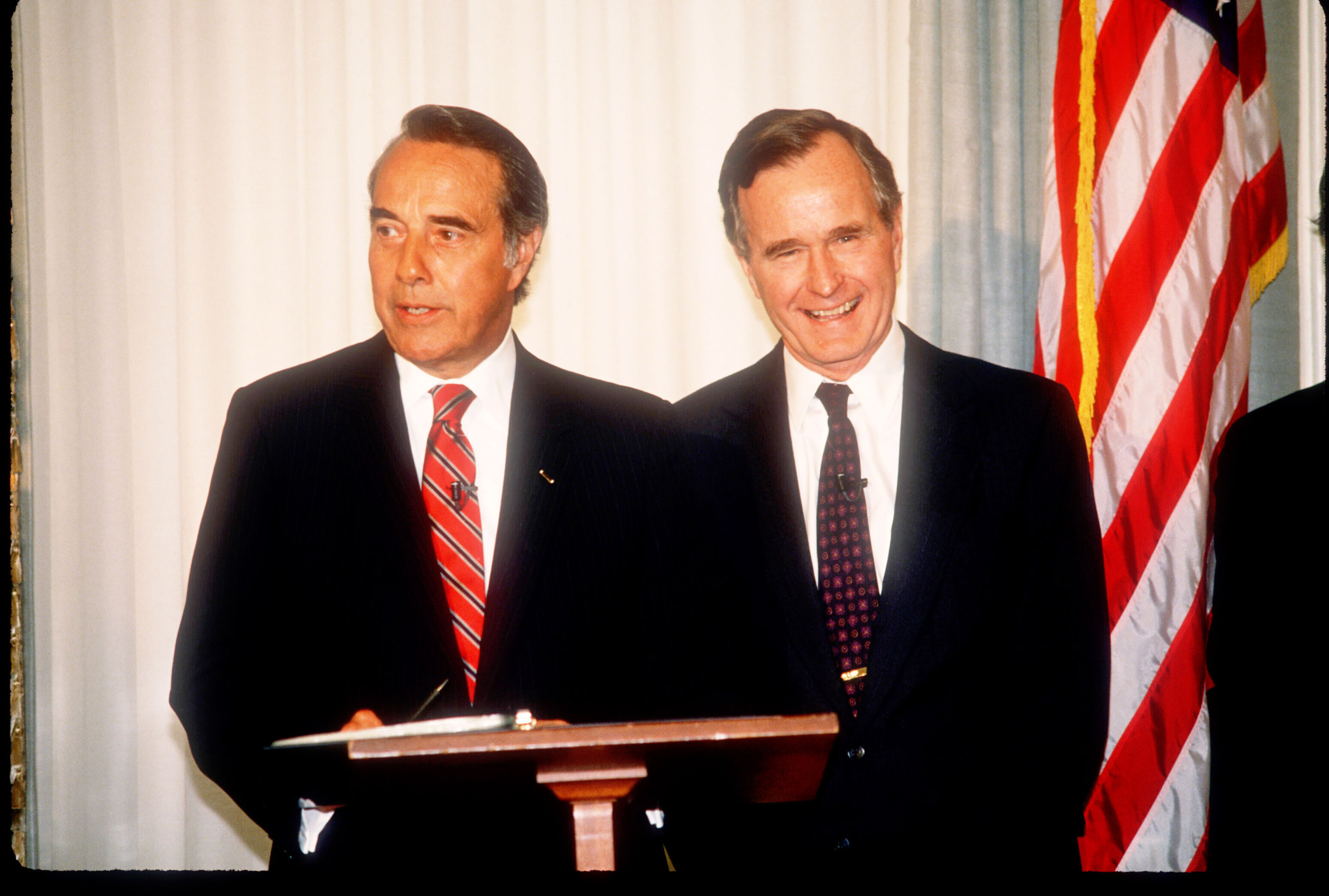 George Herbert Walker Bush stands with Bob Dole in Washington, D.C., on April 15, 1988.