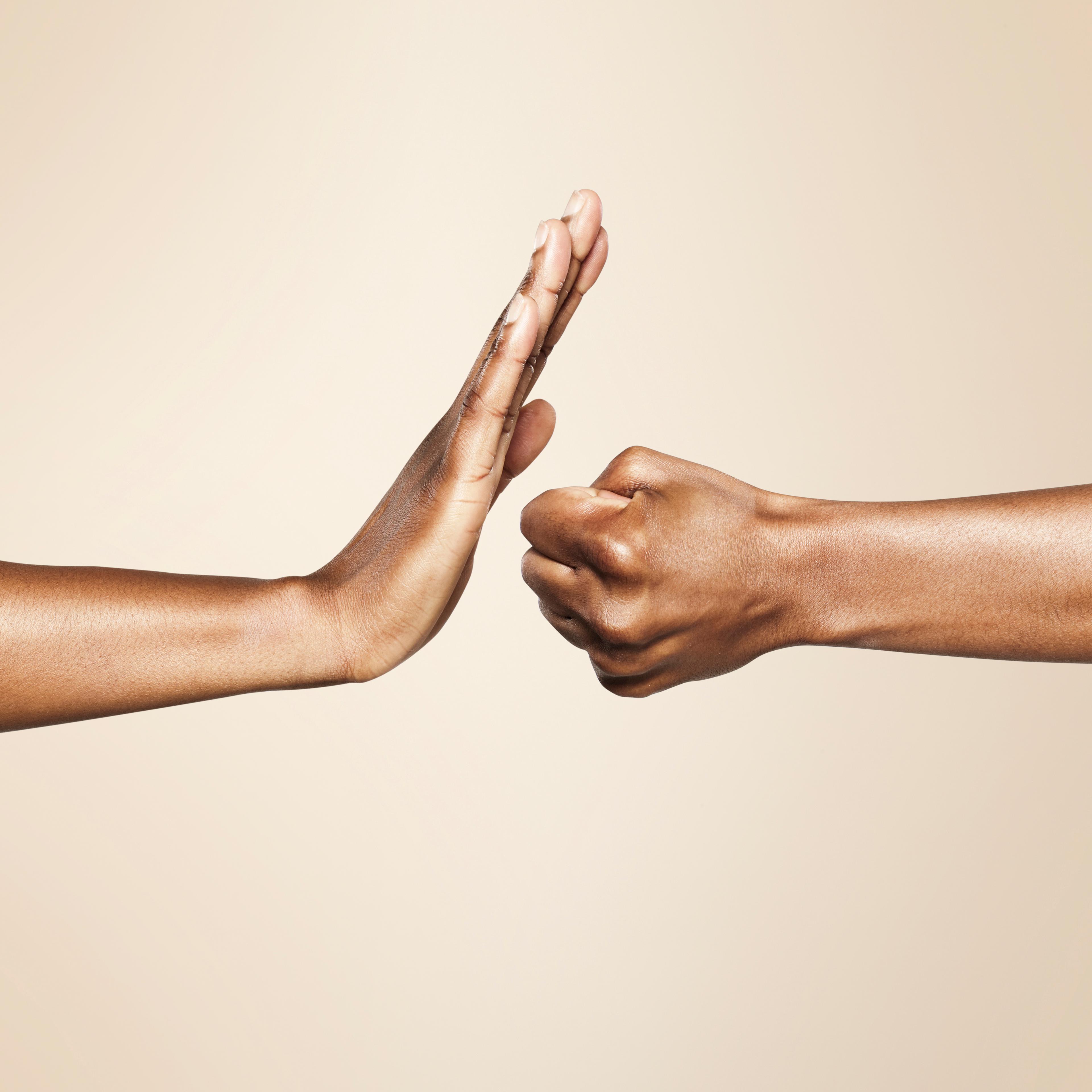 hands forming signs for offense and defense