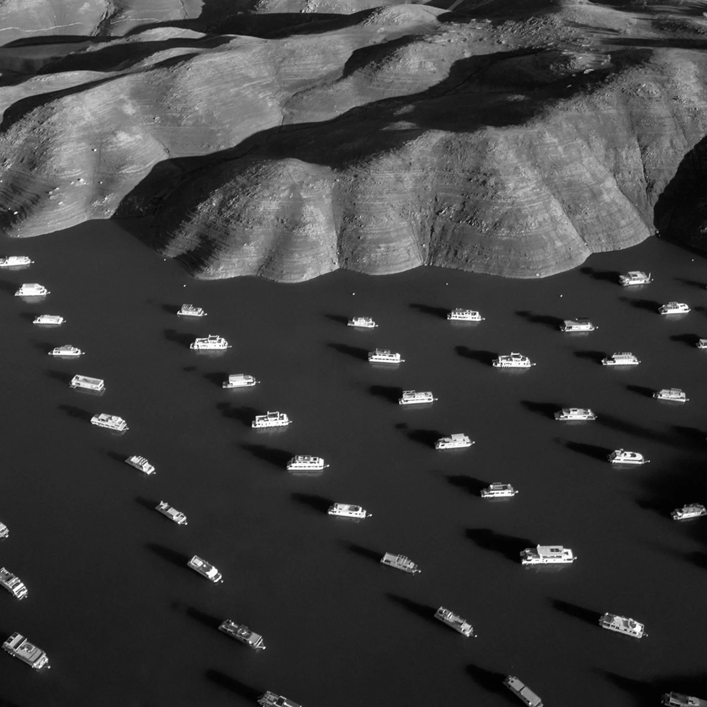 House boats appear next to the shoreline of Bidwell Canyon on Lake Oroville in Northern California on November 25, 2014. Lake Oroville is California's second largest reservoir, and is currently 70% empty as a result of the state's severe drought.