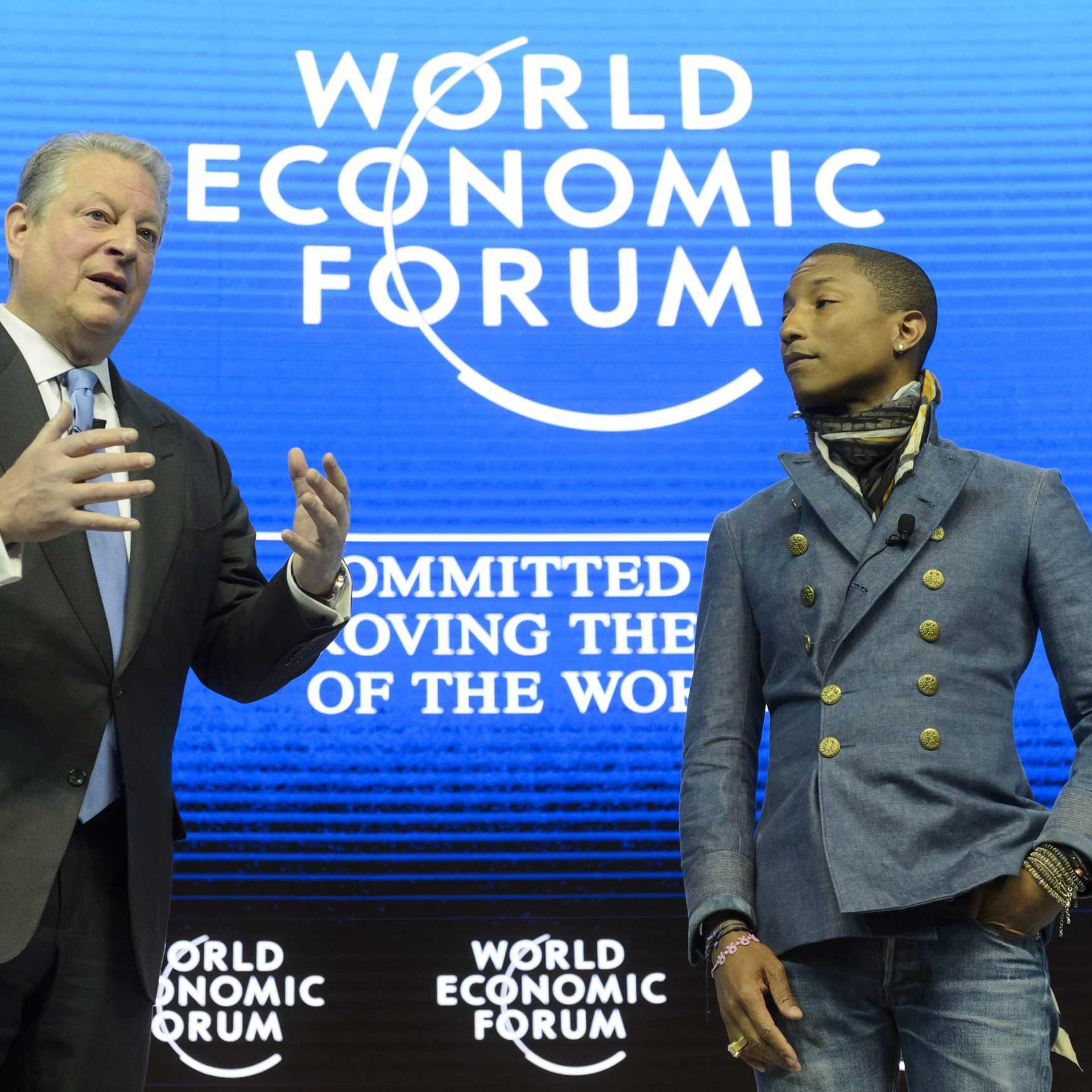 Former US Vice President Al Gore speaks next to US rapper Pharrell Williams during a panel session on the first day of the 45th Annual Meeting of the World Economic Forum, in Davos, Jan. 21, 2015.