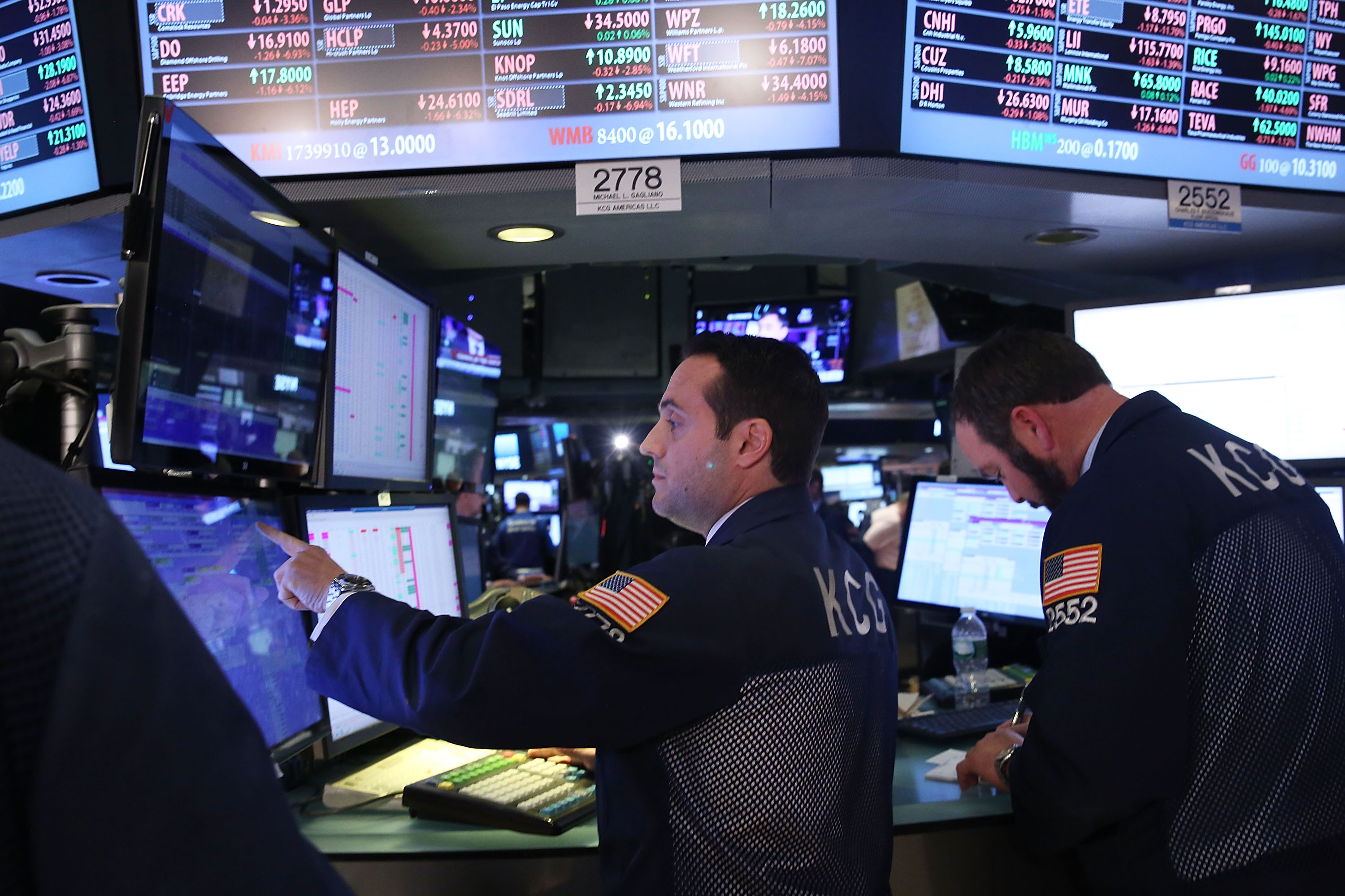Traders work on the floor of the New York Stock Exchange (NYSE) at the end of the day on January 15, 2016 in New York City.