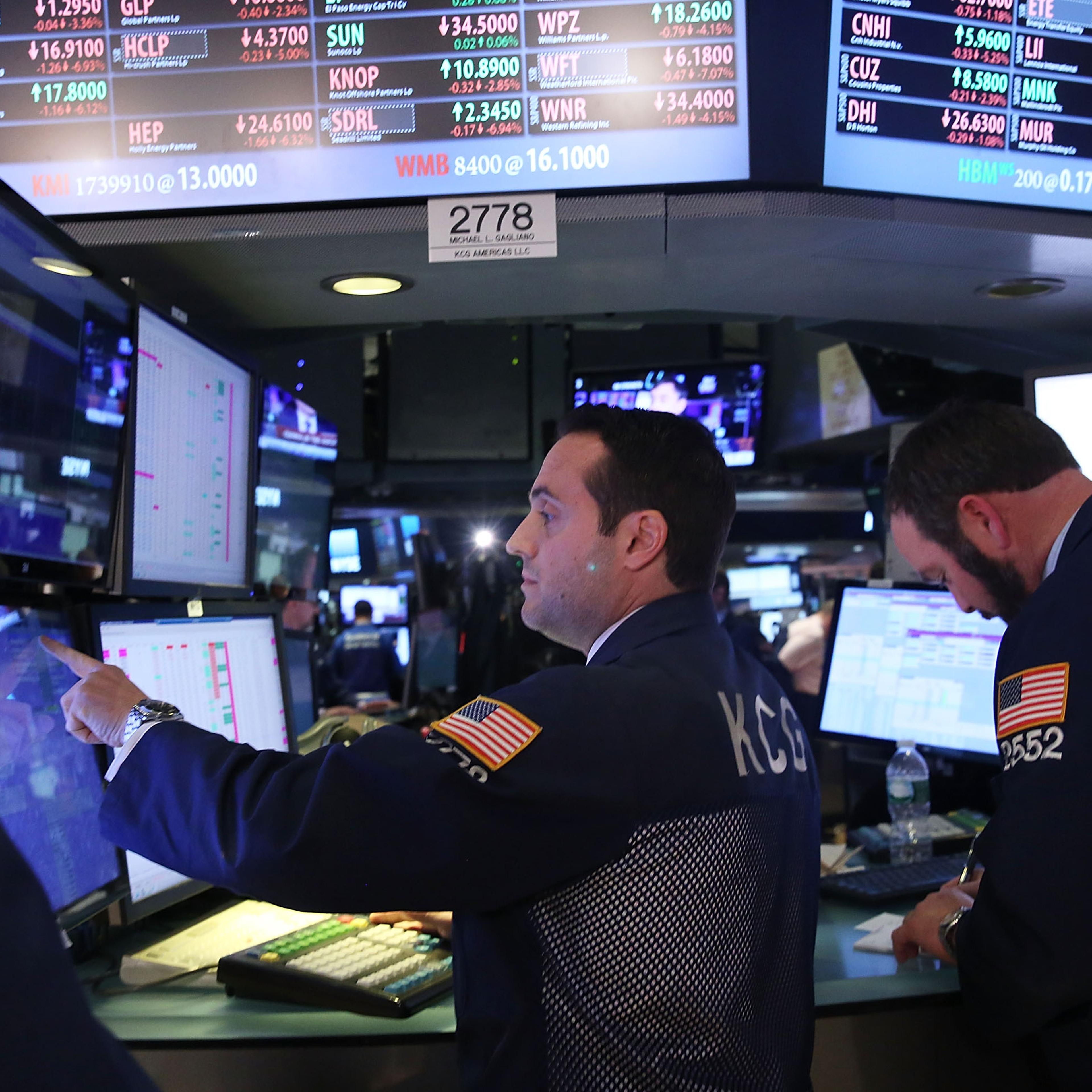 Traders work on the floor of the New York Stock Exchange (NYSE) at the end of the day on January 15, 2016 in New York City.