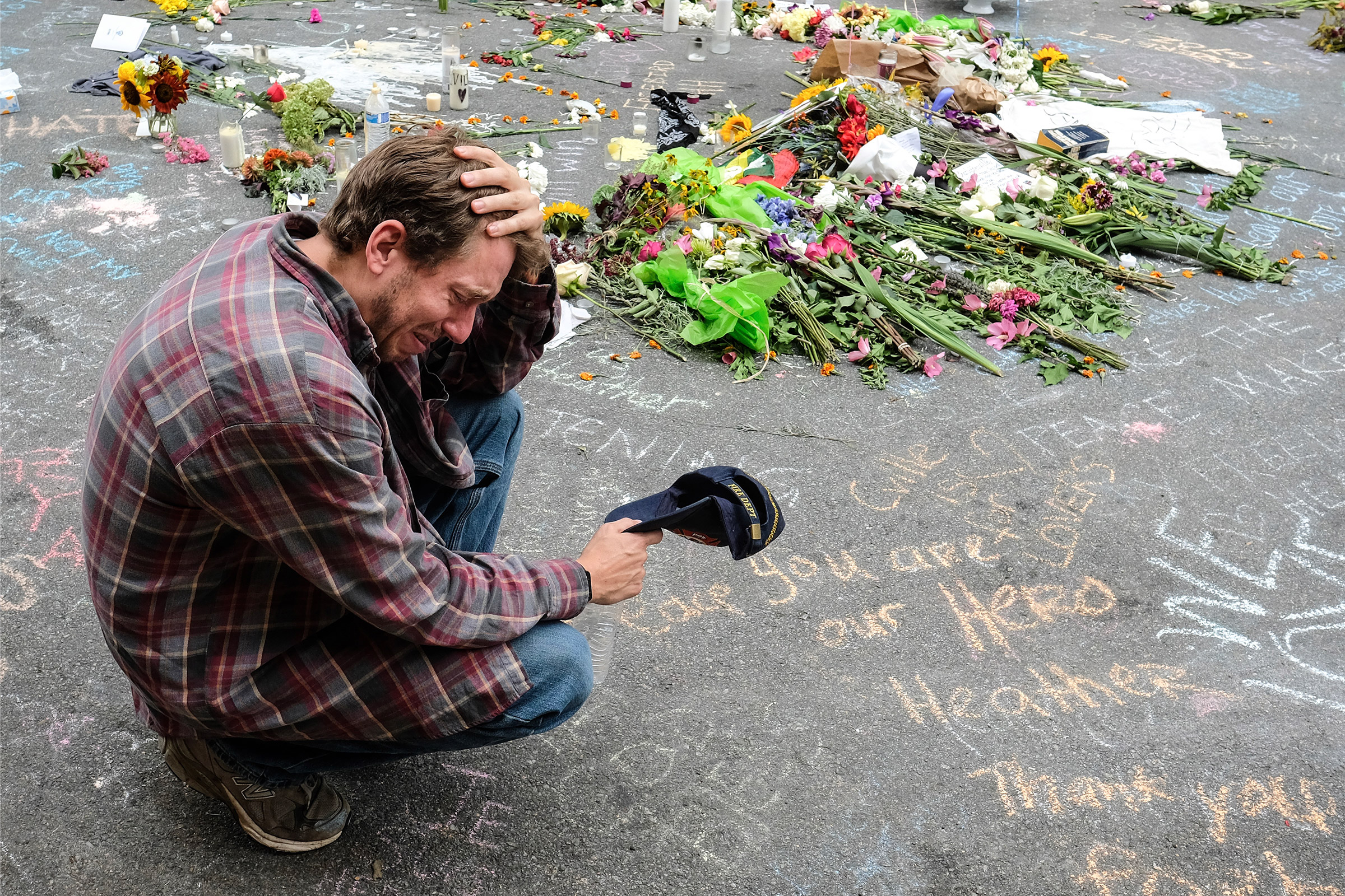 A mourner visits the spot where Heather Heyer died in Charlottesville, Va., on Aug. 12, 2017.