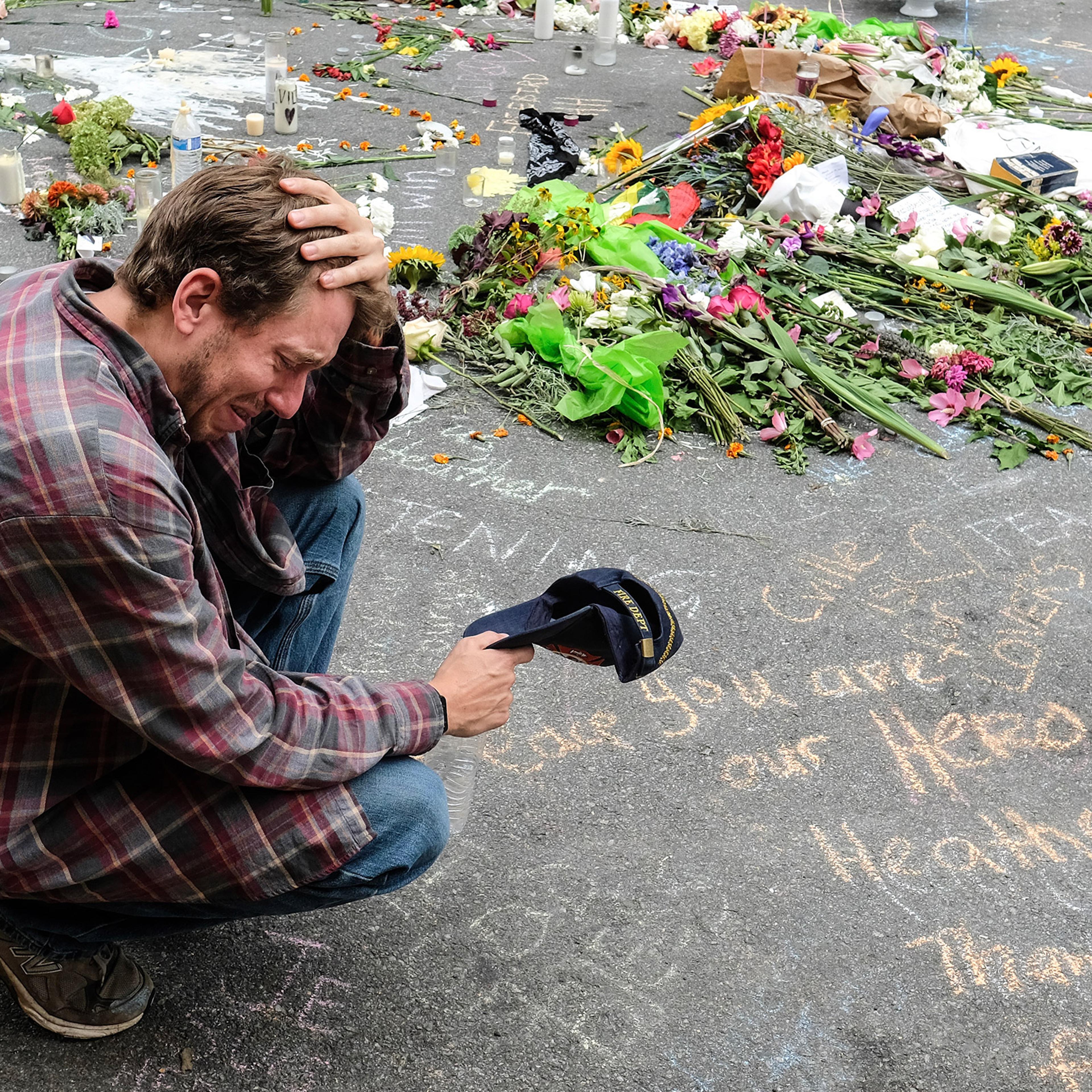 A mourner visits the spot where Heather Heyer died in Charlottesville, Va., on Aug. 12, 2017.