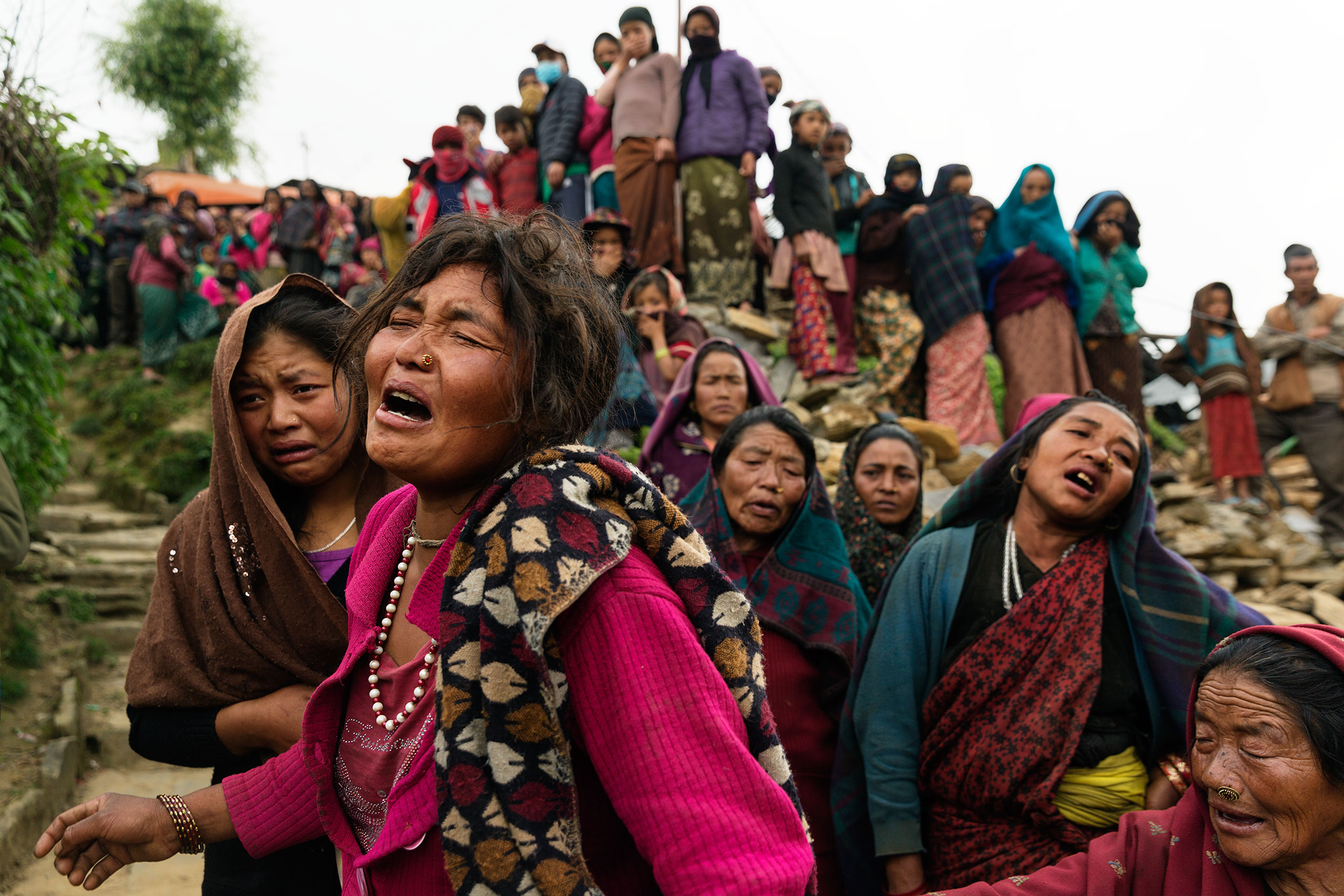 Nepal earthquake. Gumda Village, in Ghorka district. 5 people died and 14 are still missing in landslides. Inhabitants salvaging building materials from their destroyed houses. Funeral of Rejina Gurung, 3 who was just discovered buried in the rubble. Her