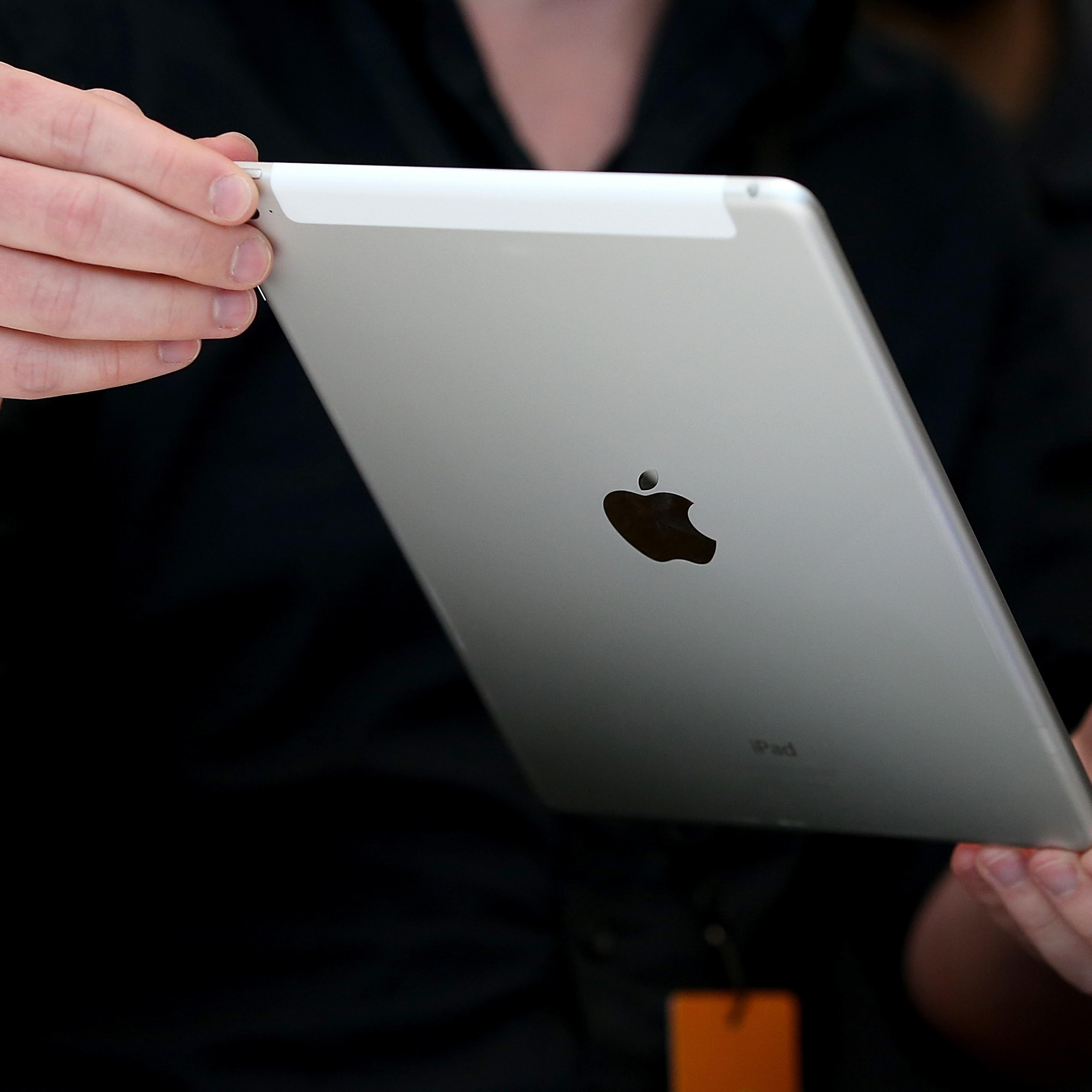 An attendee inspects new iPad Air 2 during an Apple special event on Oct. 16, 2014 in Cupertino, Calif.