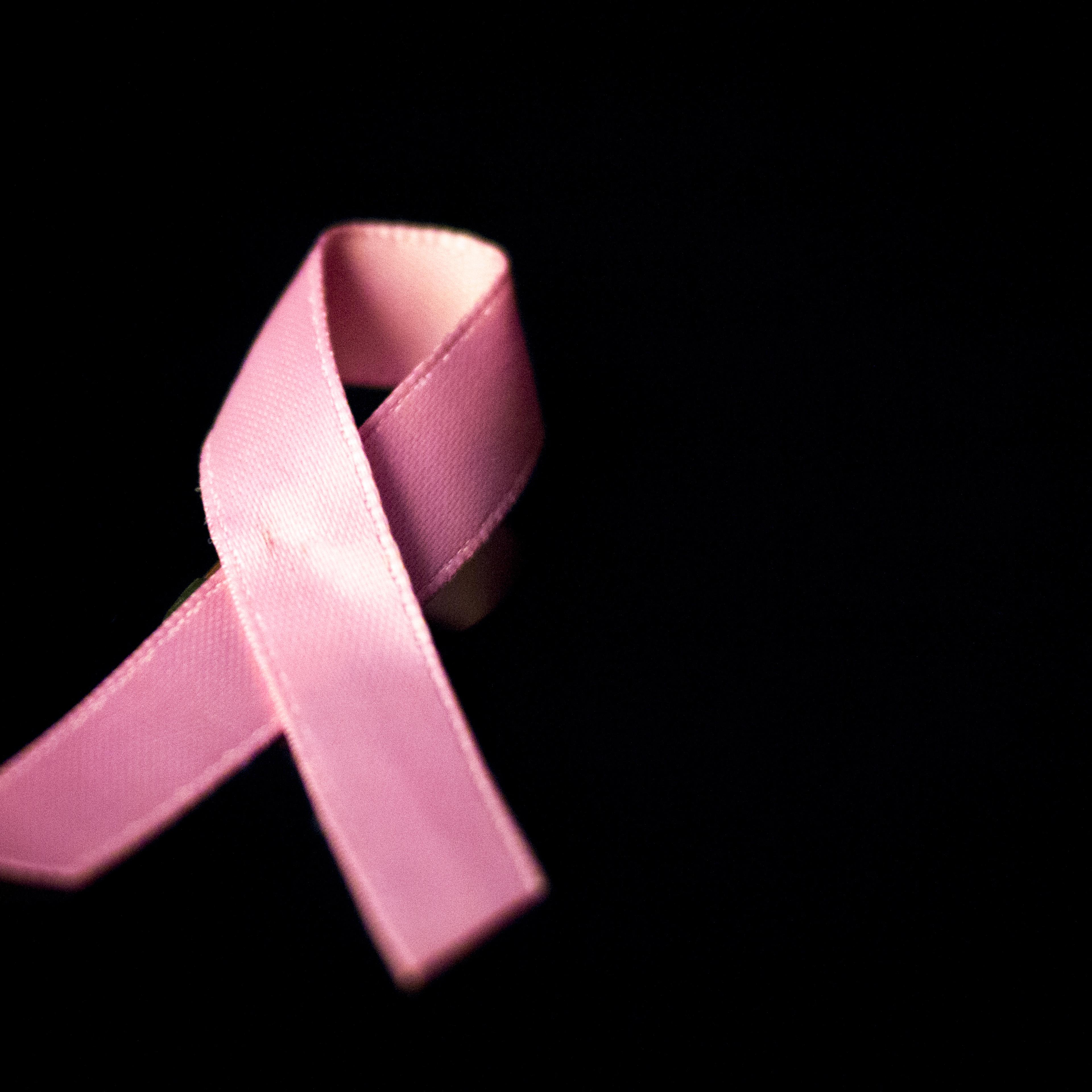 Pink breast cancer ribbon bow symbol