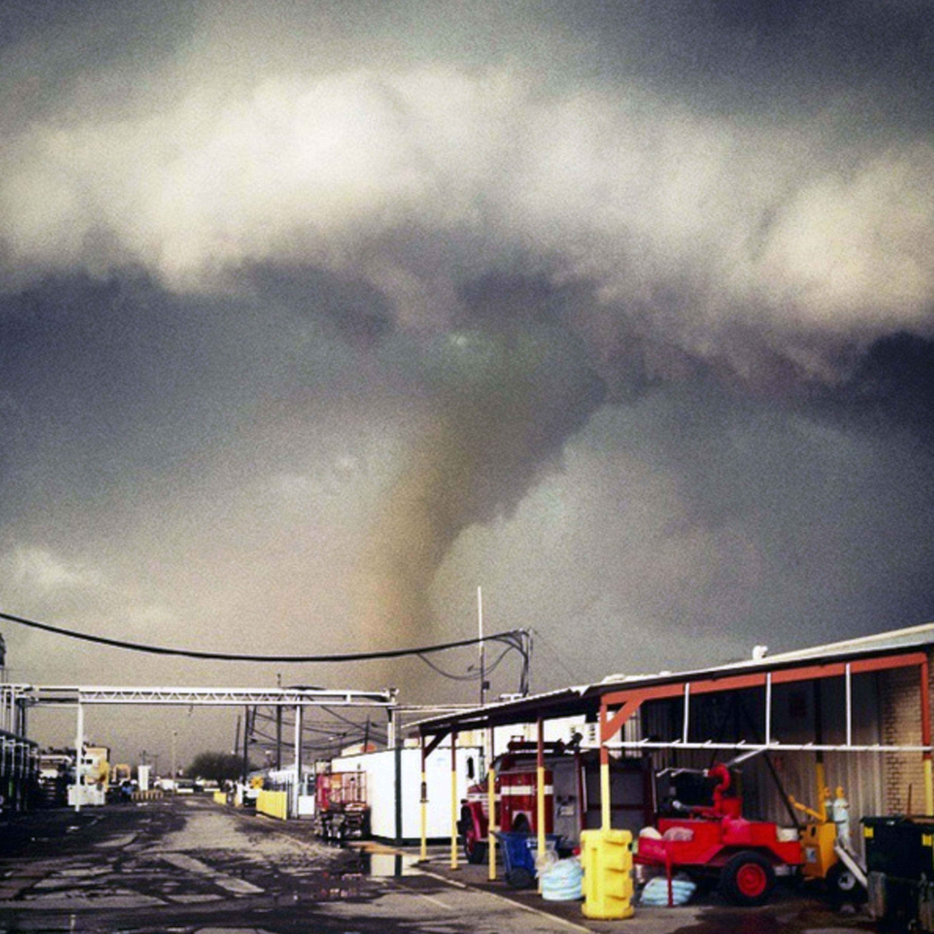 The funnel cloud of a tornado reaches down to the ground as a storm approaches Sand Springs, Okla. on March 25, 2015.