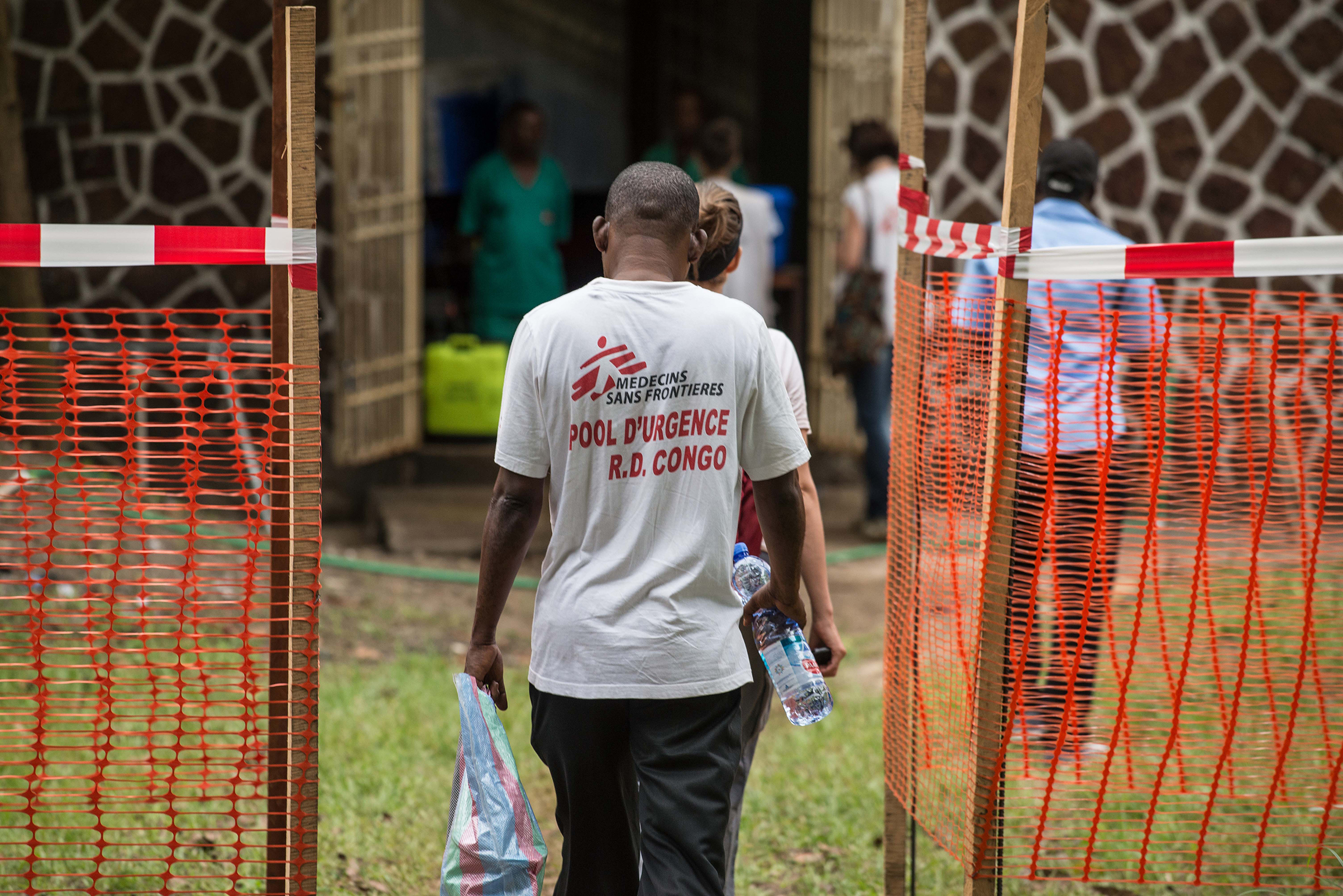 Médecins sans frontière team members walk through an Ebola security zone in Mbandaka, Democratic Republic of Congo, on May 20, 2018
