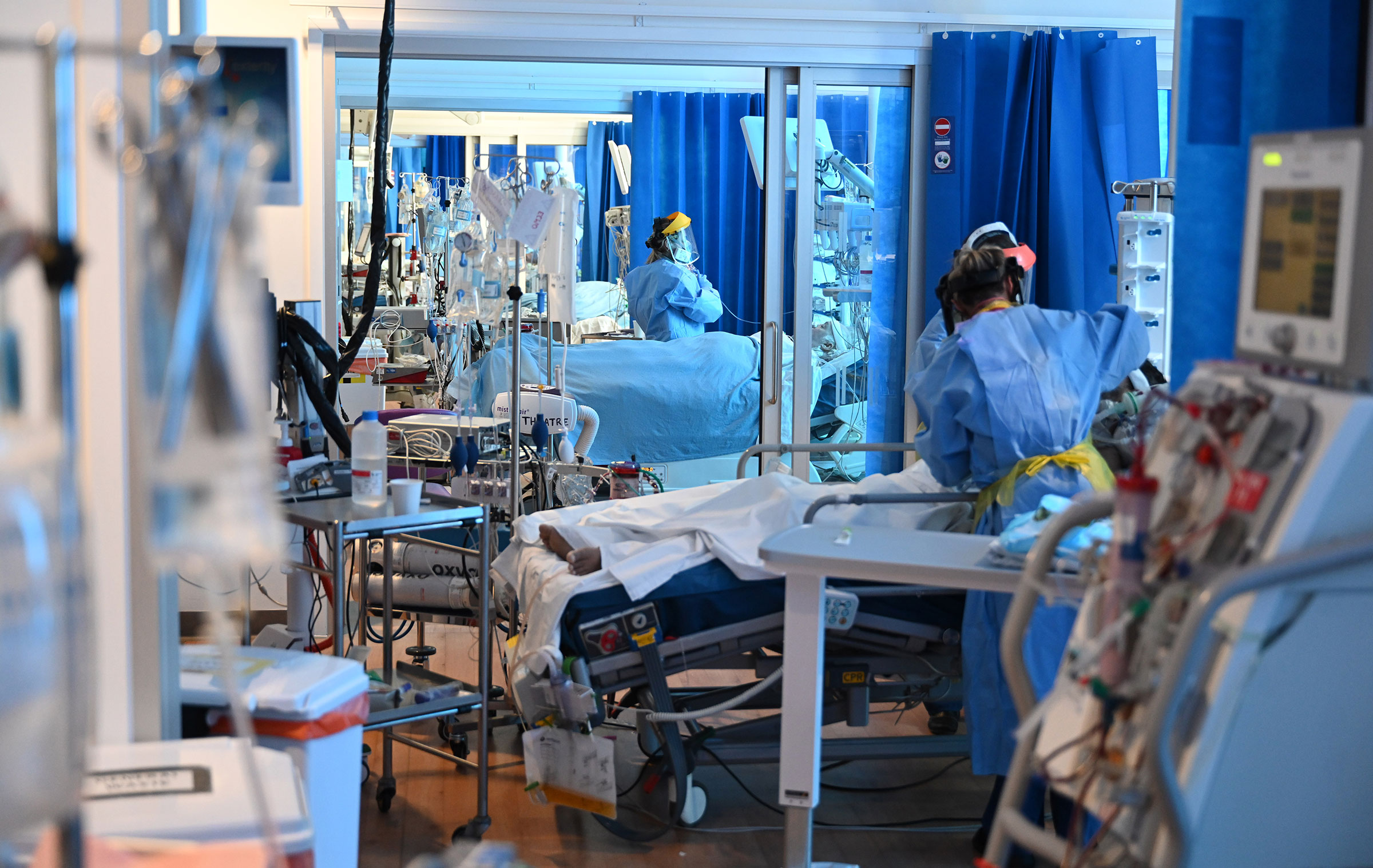 Clinical staff wear personal protective equipment as they care for patients at the Intensive Care unit at Royal Papworth Hospital in Cambridge