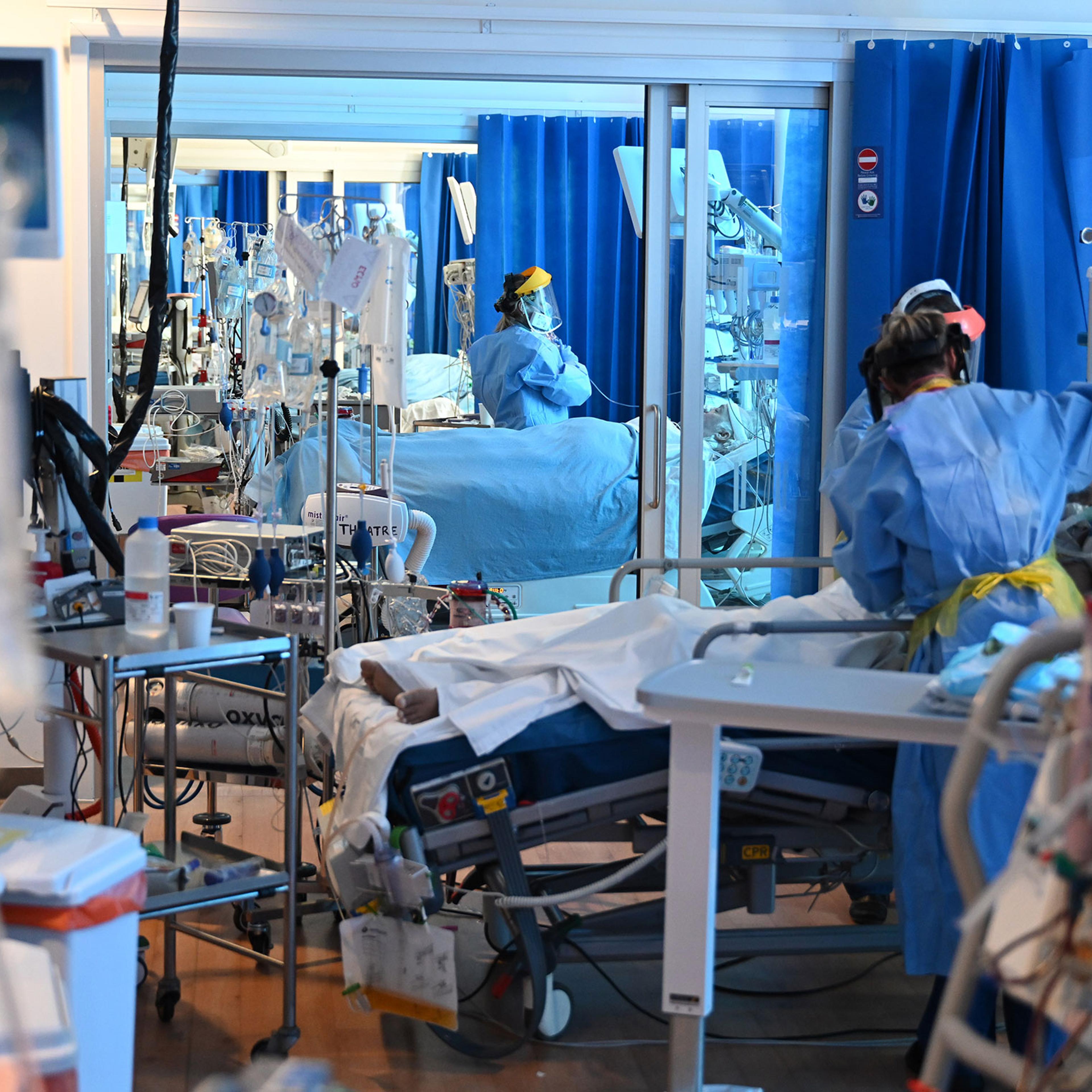 Clinical staff wear personal protective equipment as they care for patients at the Intensive Care unit at Royal Papworth Hospital in Cambridge