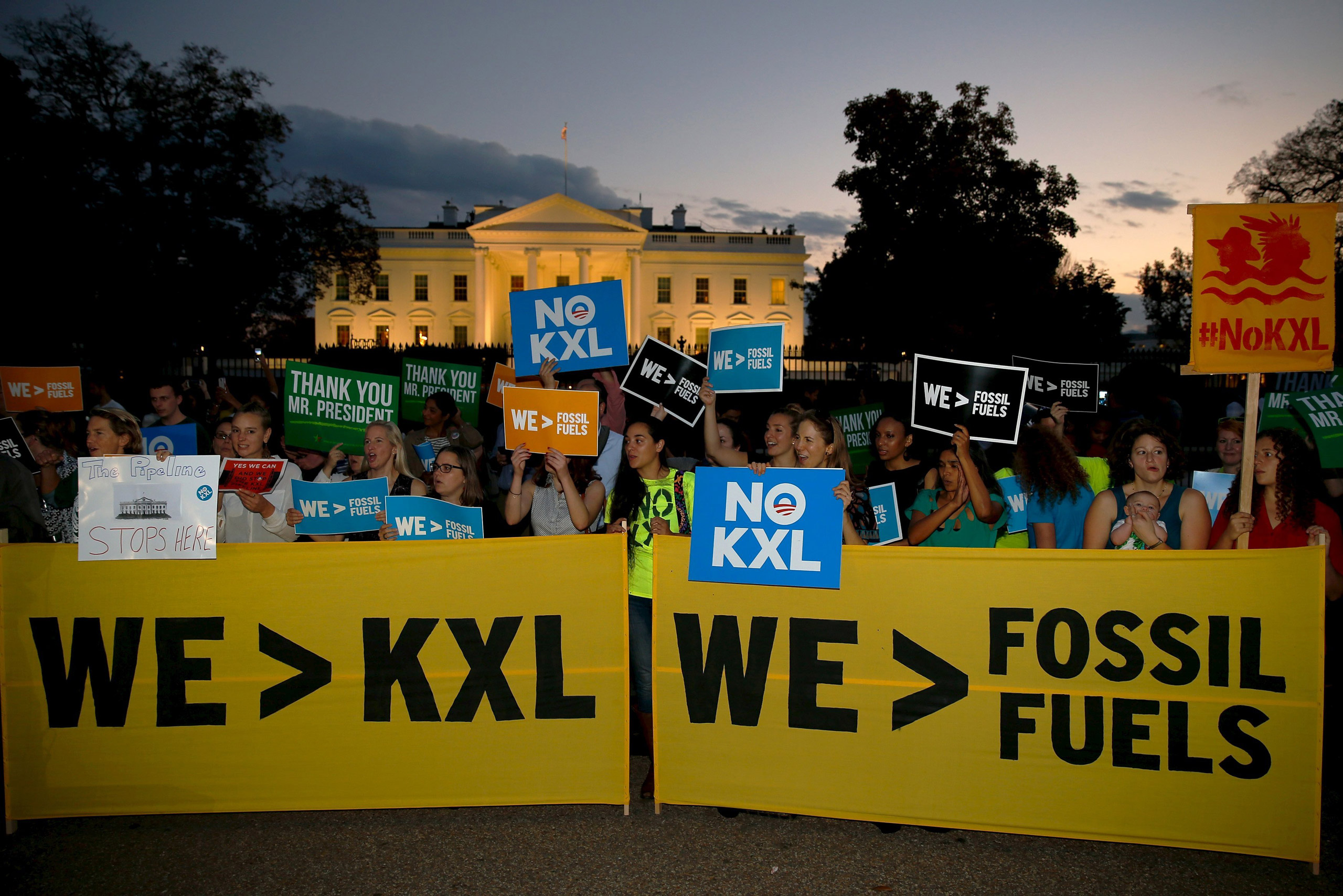 A small group of activists gather to celebrate the Obama administration's rejection of the Keystone XL pipeline, outside the White House in Washington