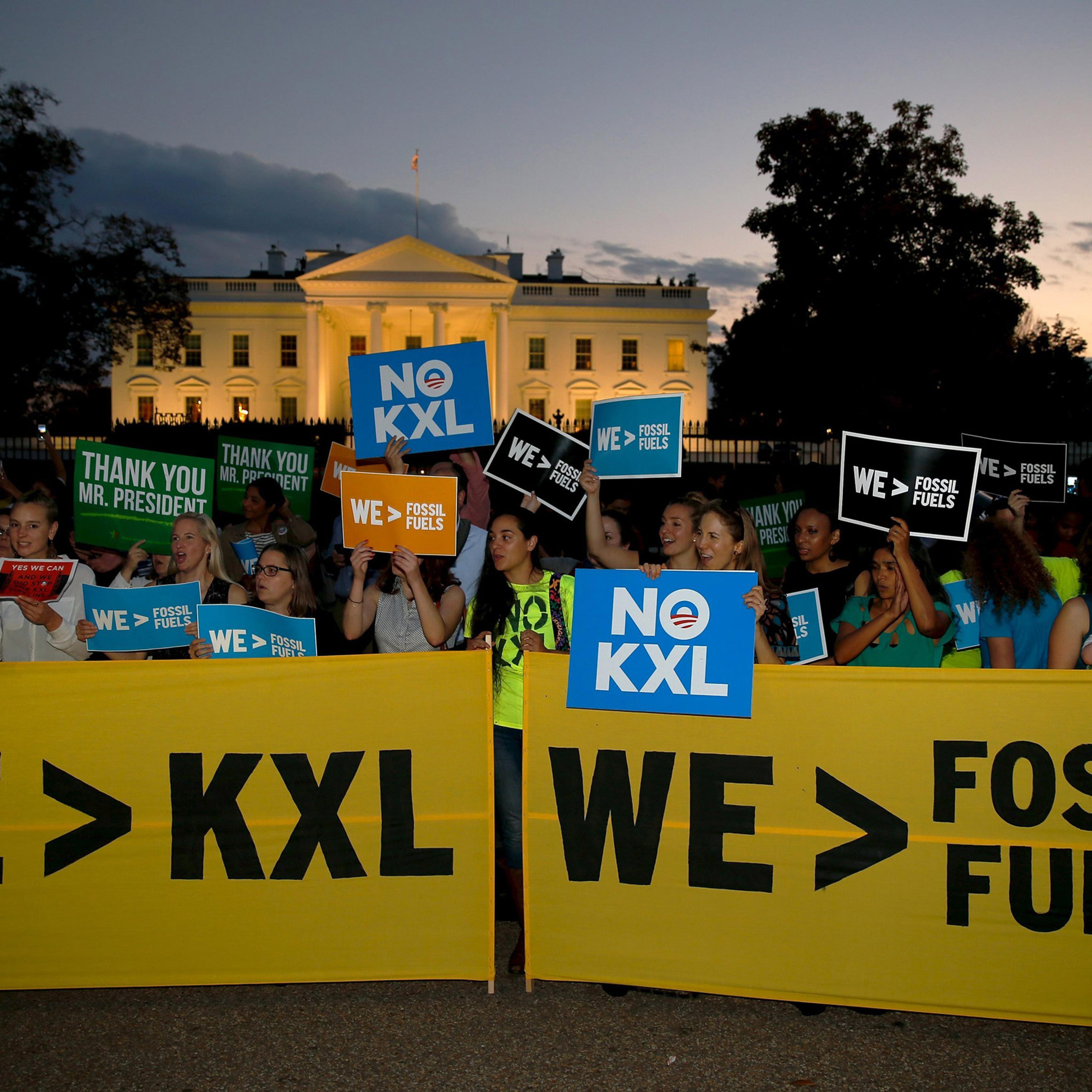 A small group of activists gather to celebrate the Obama administration's rejection of the Keystone XL pipeline, outside the White House in Washington