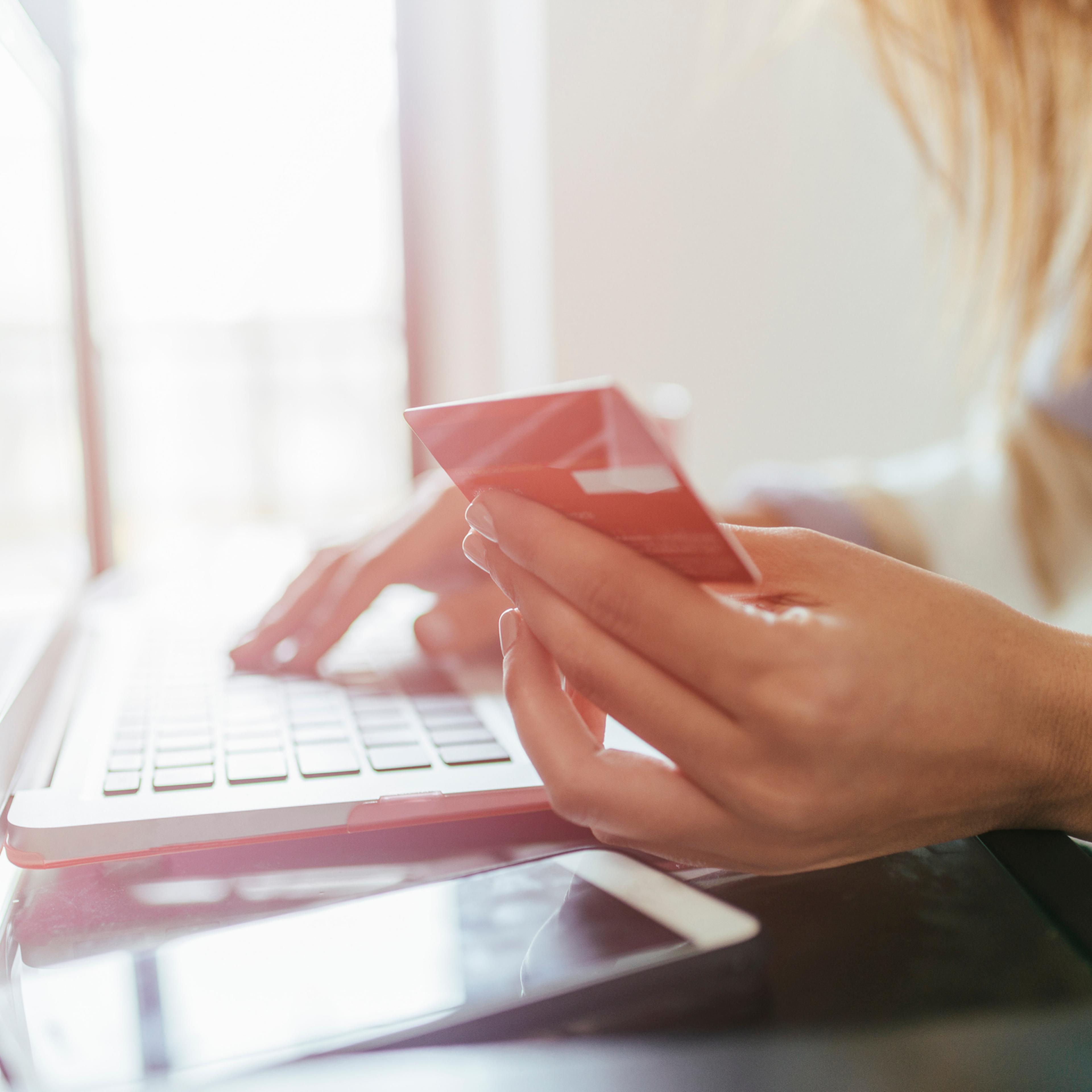 Close-up of woman buying from home on the laptop