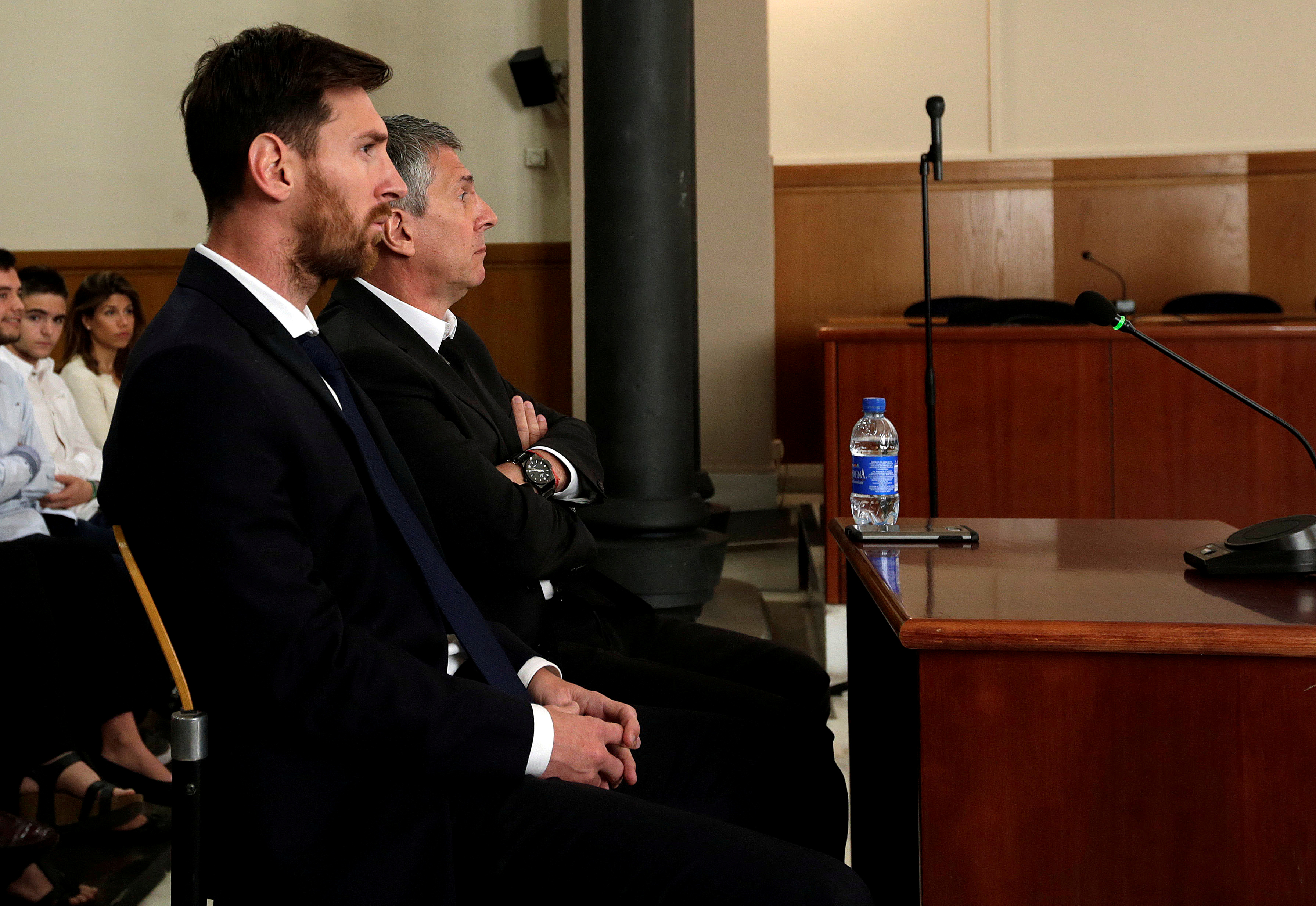 Barcelona's Argentine soccer player Lionel Messi sits in court with his father Jorge Horacio Messi during their trial for tax fraud in Barcelona