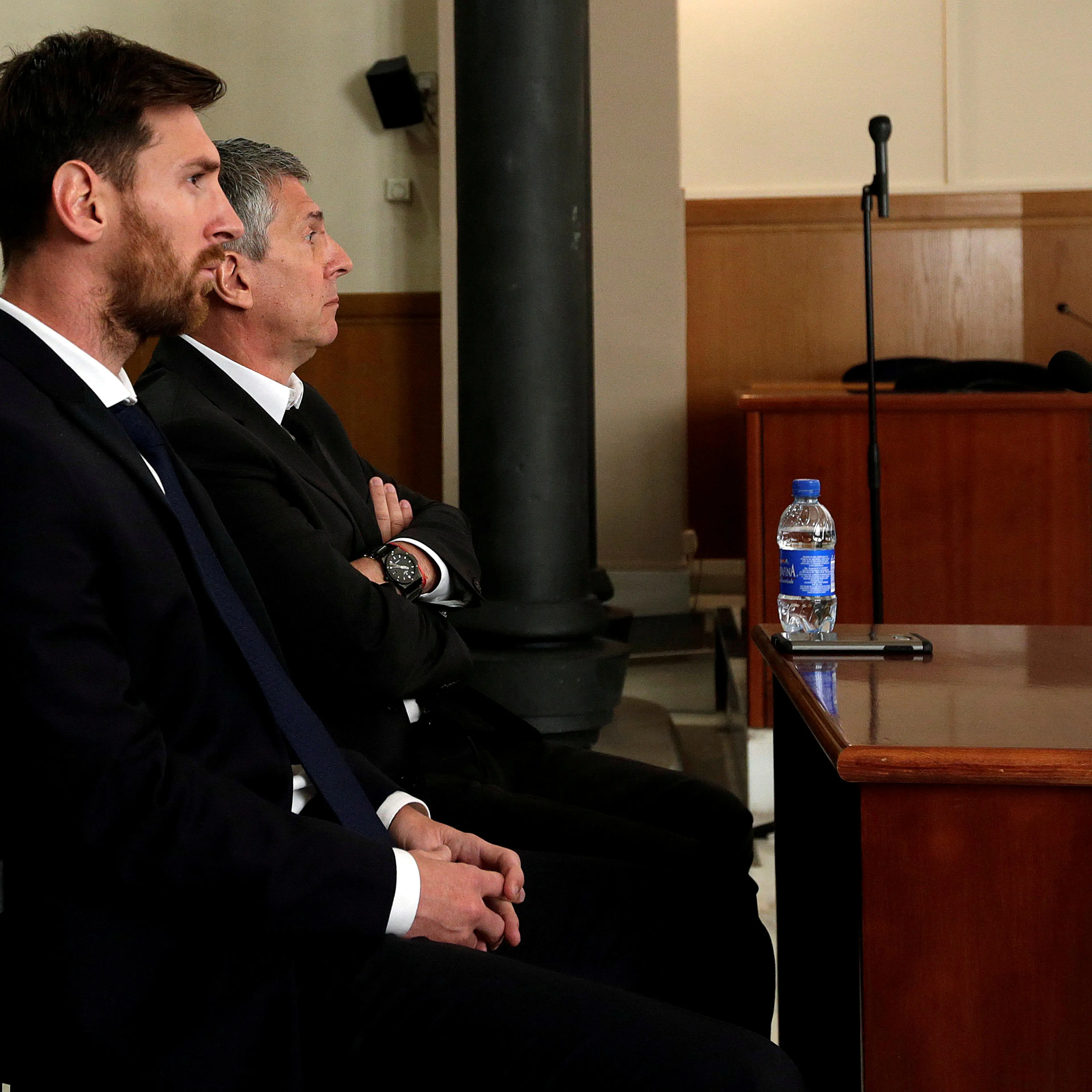 Barcelona's Argentine soccer player Lionel Messi sits in court with his father Jorge Horacio Messi during their trial for tax fraud in Barcelona