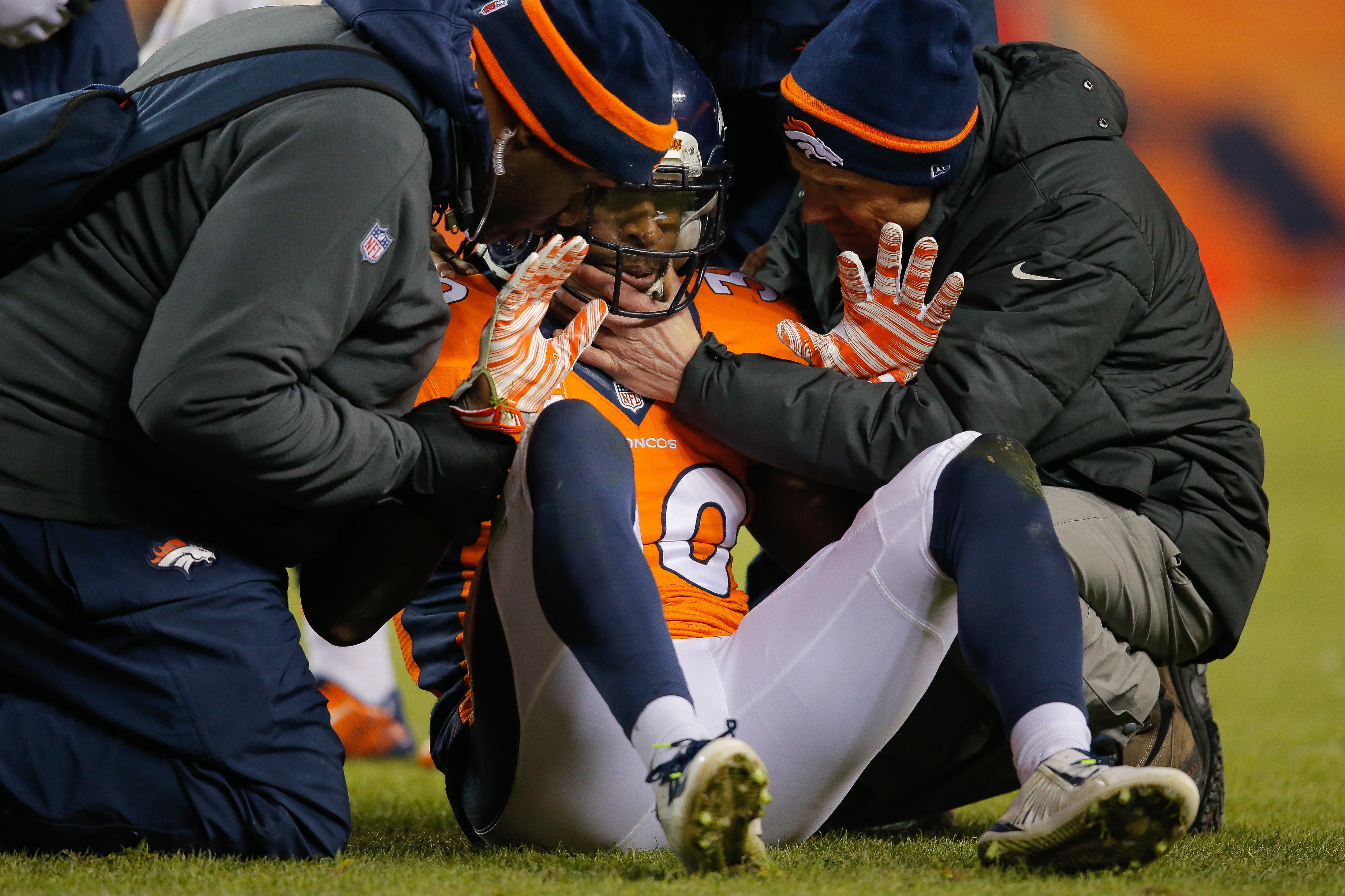 Strong safety David Bruton #30 of the Denver Broncos is attended to by trainers after a play that would force him out of the game with a reported concussion during a game against the Oakland Raiders at Sports Authority Field at Mile High on December 28, 