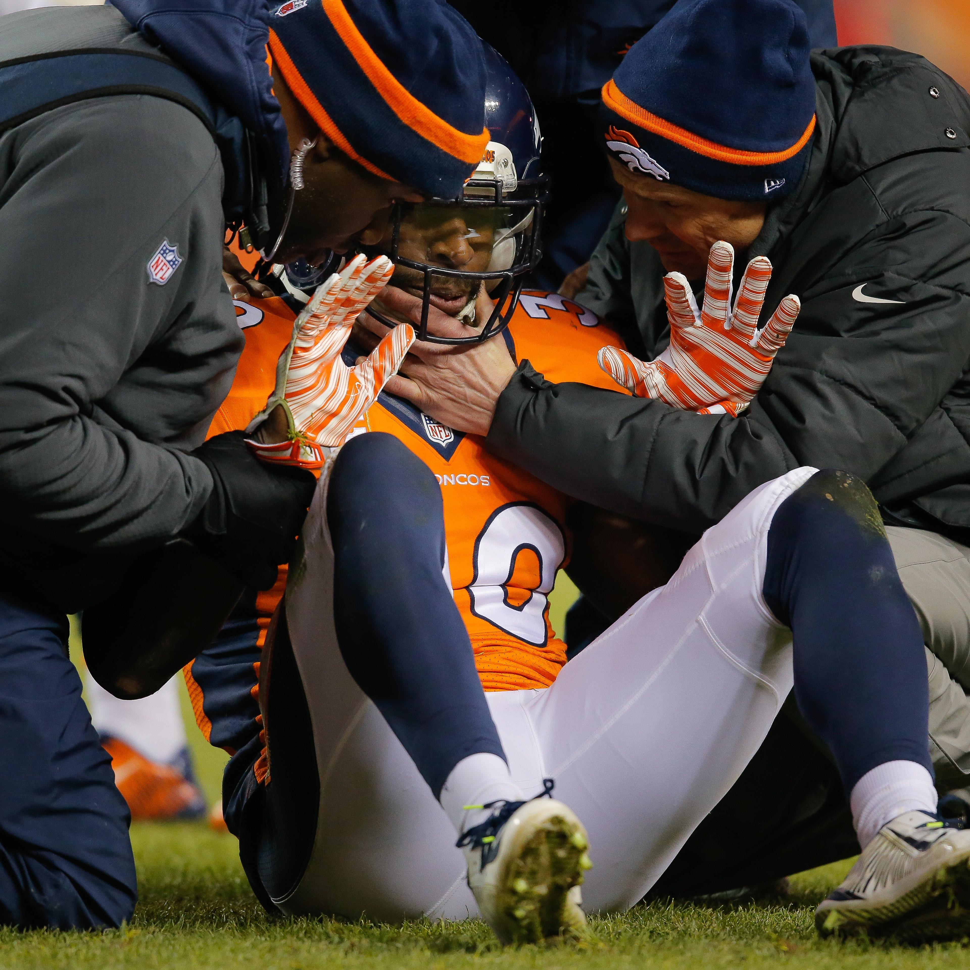Strong safety David Bruton #30 of the Denver Broncos is attended to by trainers after a play that would force him out of the game with a reported concussion during a game against the Oakland Raiders at Sports Authority Field at Mile High on December 28,