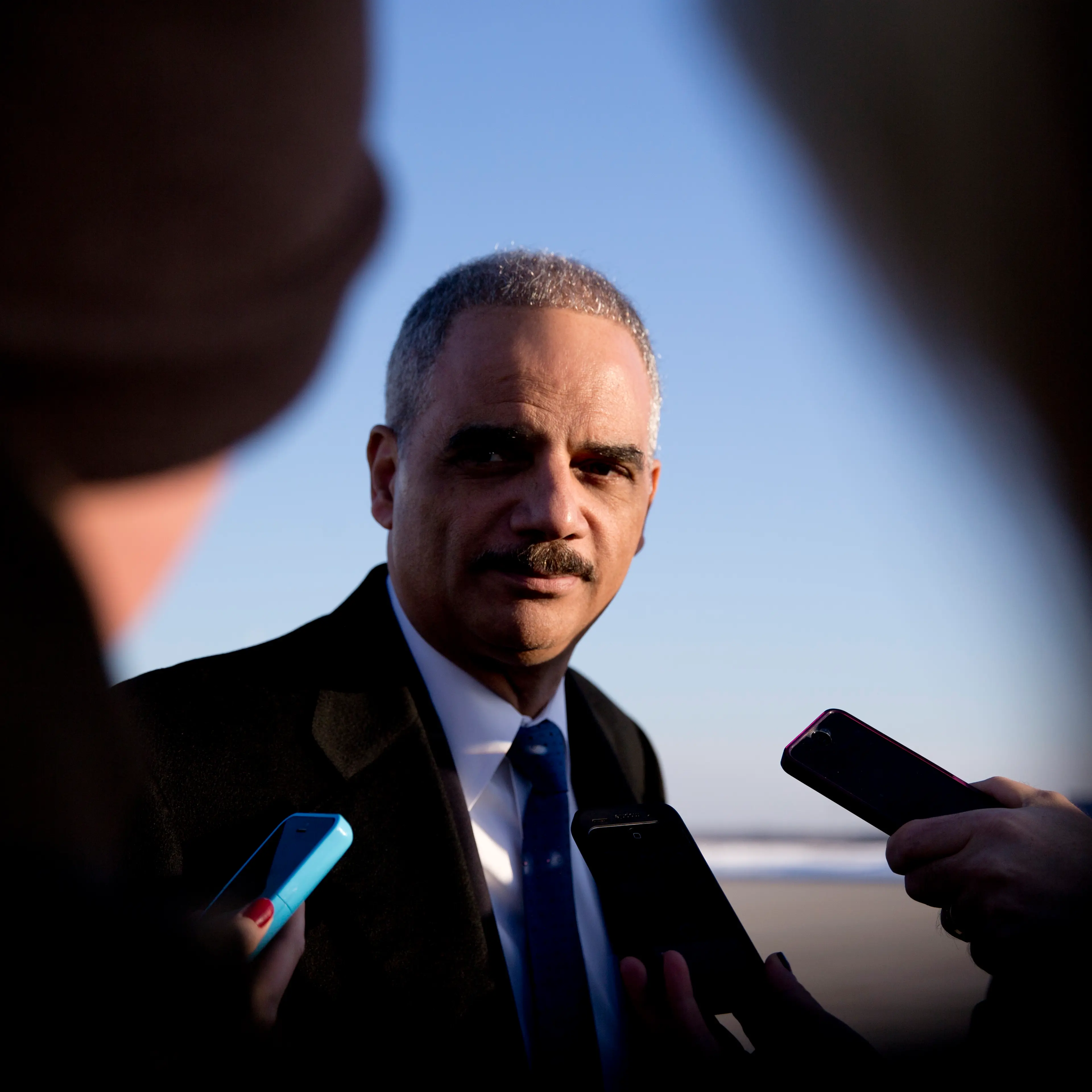 Attorney General Eric Holder talks with media as he arrives on Air Force One in Andrews Air Force Base, Md. on March 6, 2015, with President Barack Obama, from Columbia, S.C.