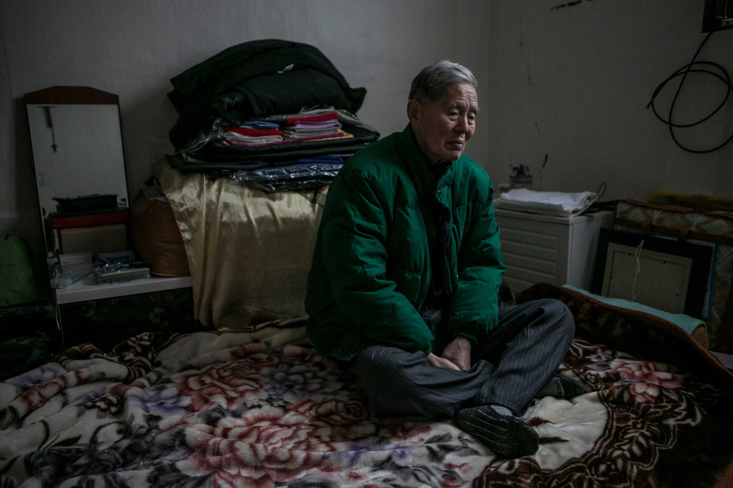 Ham Hak-joon sits in his one-room home on top of the hill in Jongro District, Seoul, South Korea in December 27, 2014. Ham, an 86-year-old man who lives by himself, has been out of contact with two of his grown-up children for more than 30 years. He has 