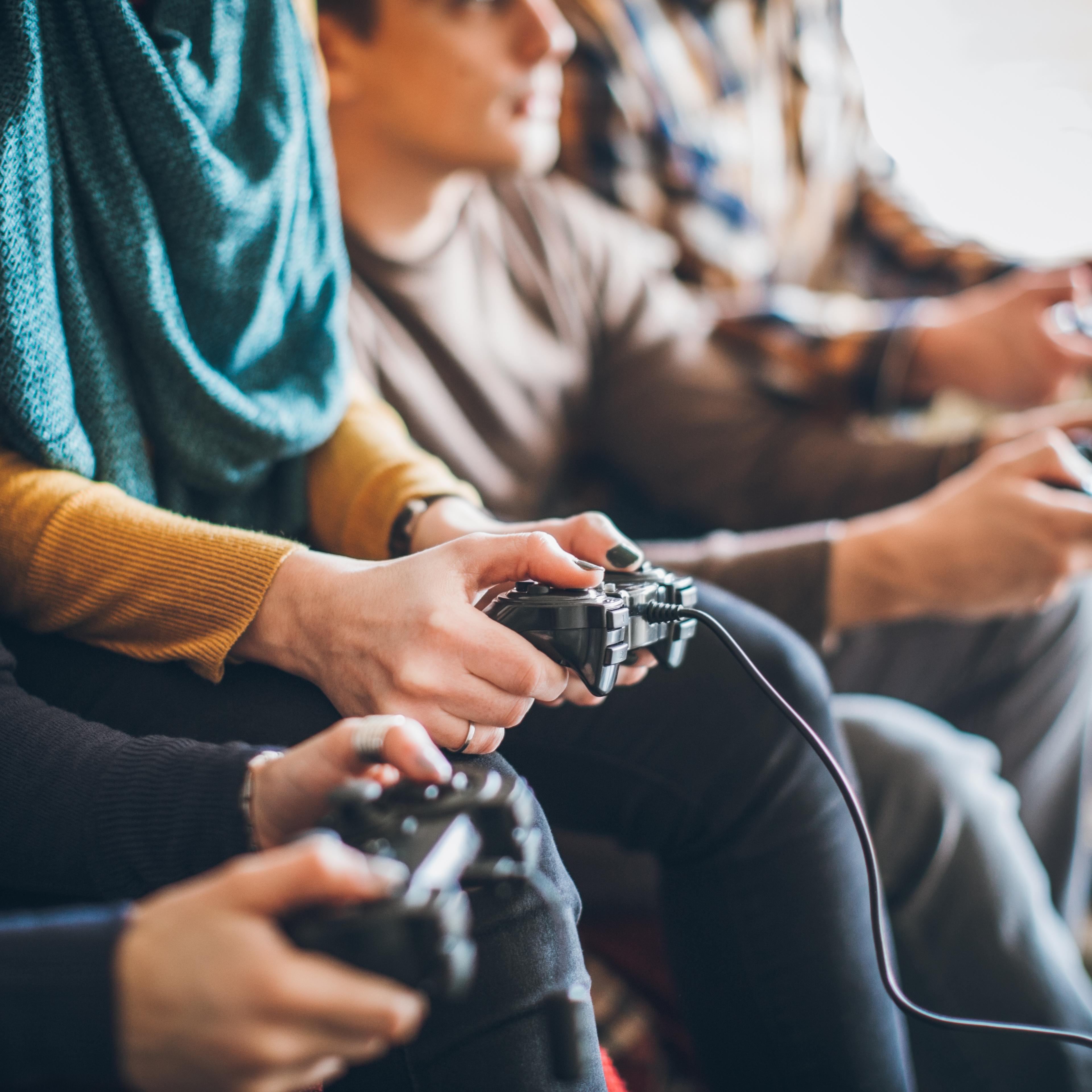 Group of friends playing digital games at home.