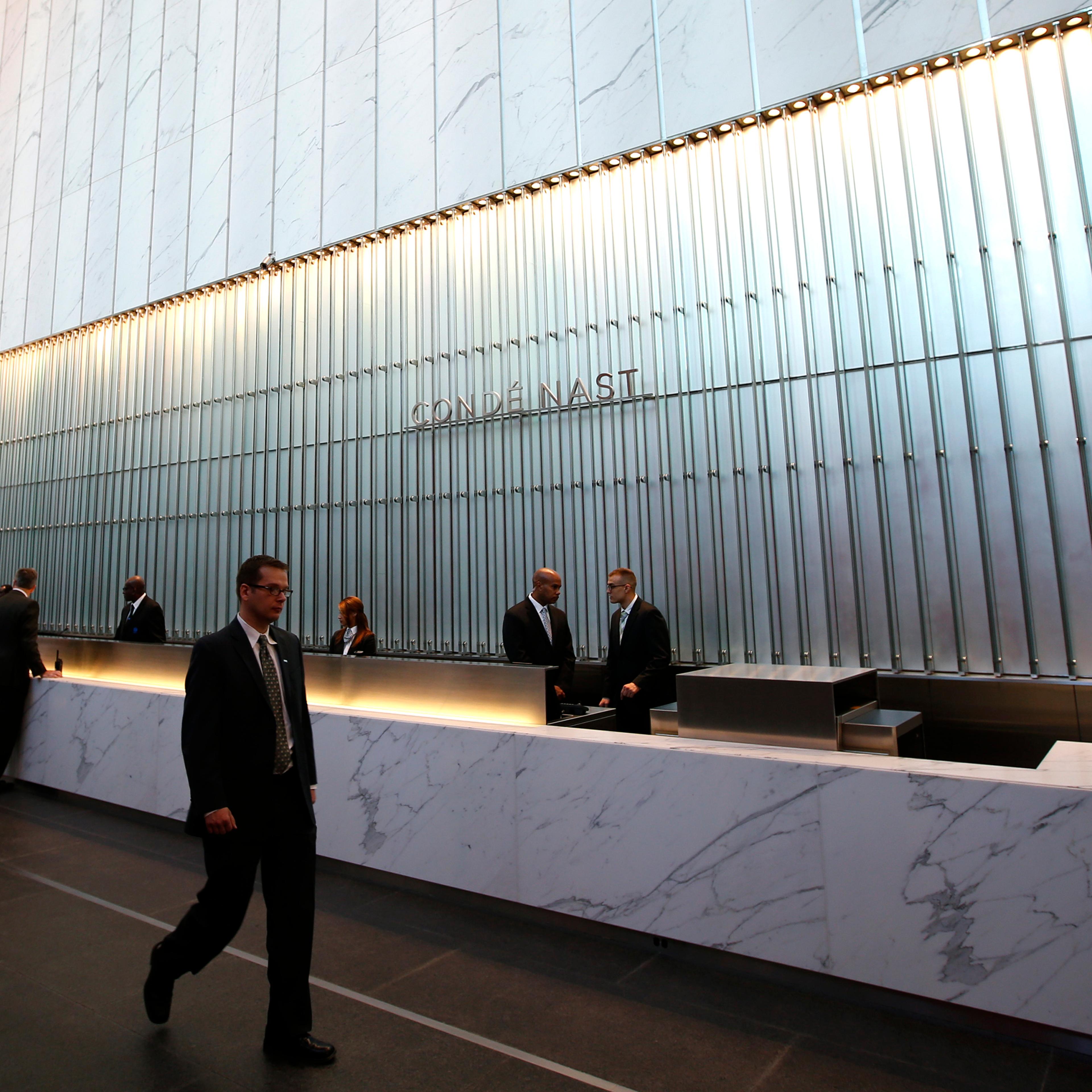 Conde Nast employees work in the lobby of the One World Trade Center tower in New York