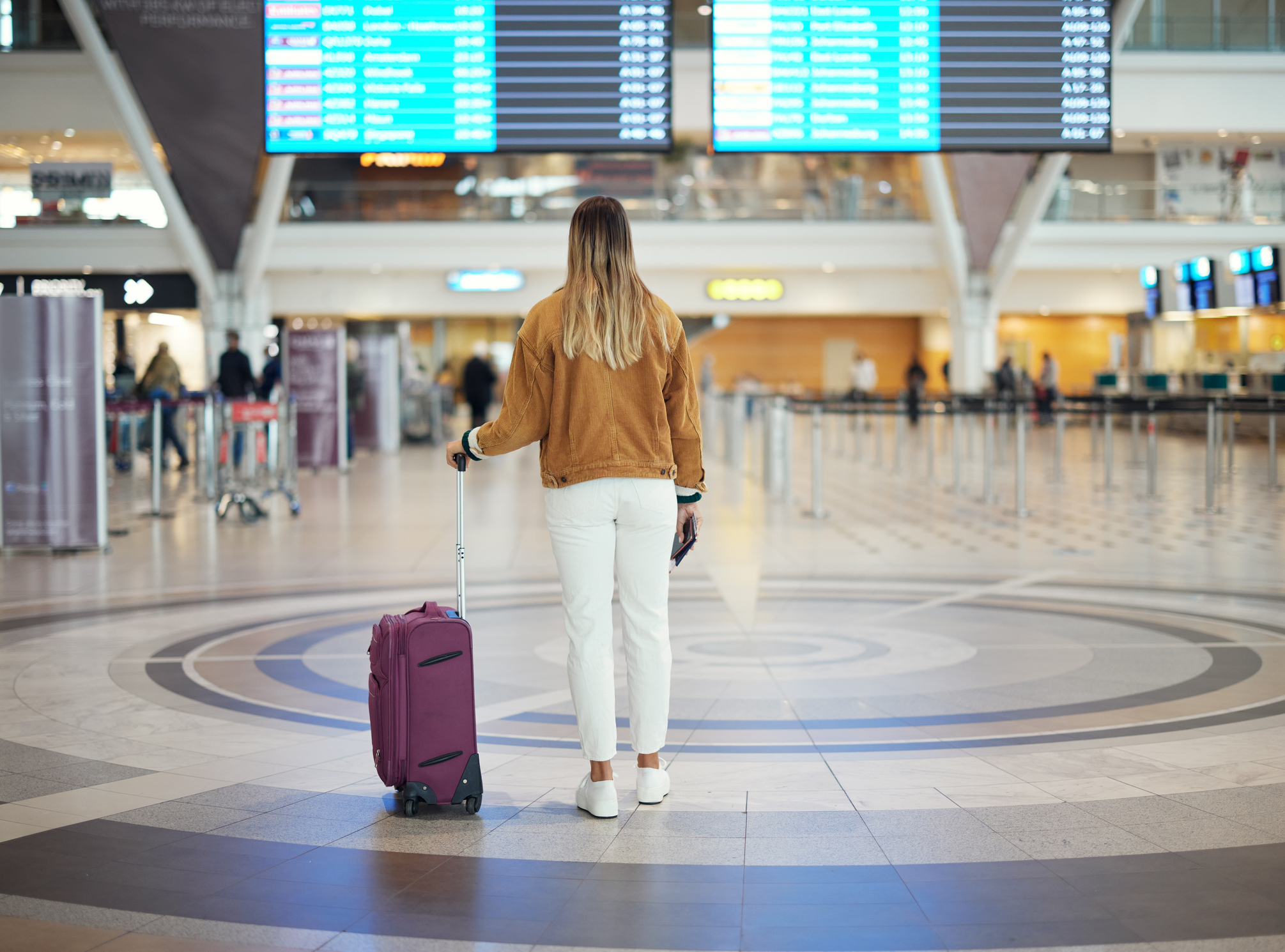 Woman at South Africa's Cape Town Airport with suitcase