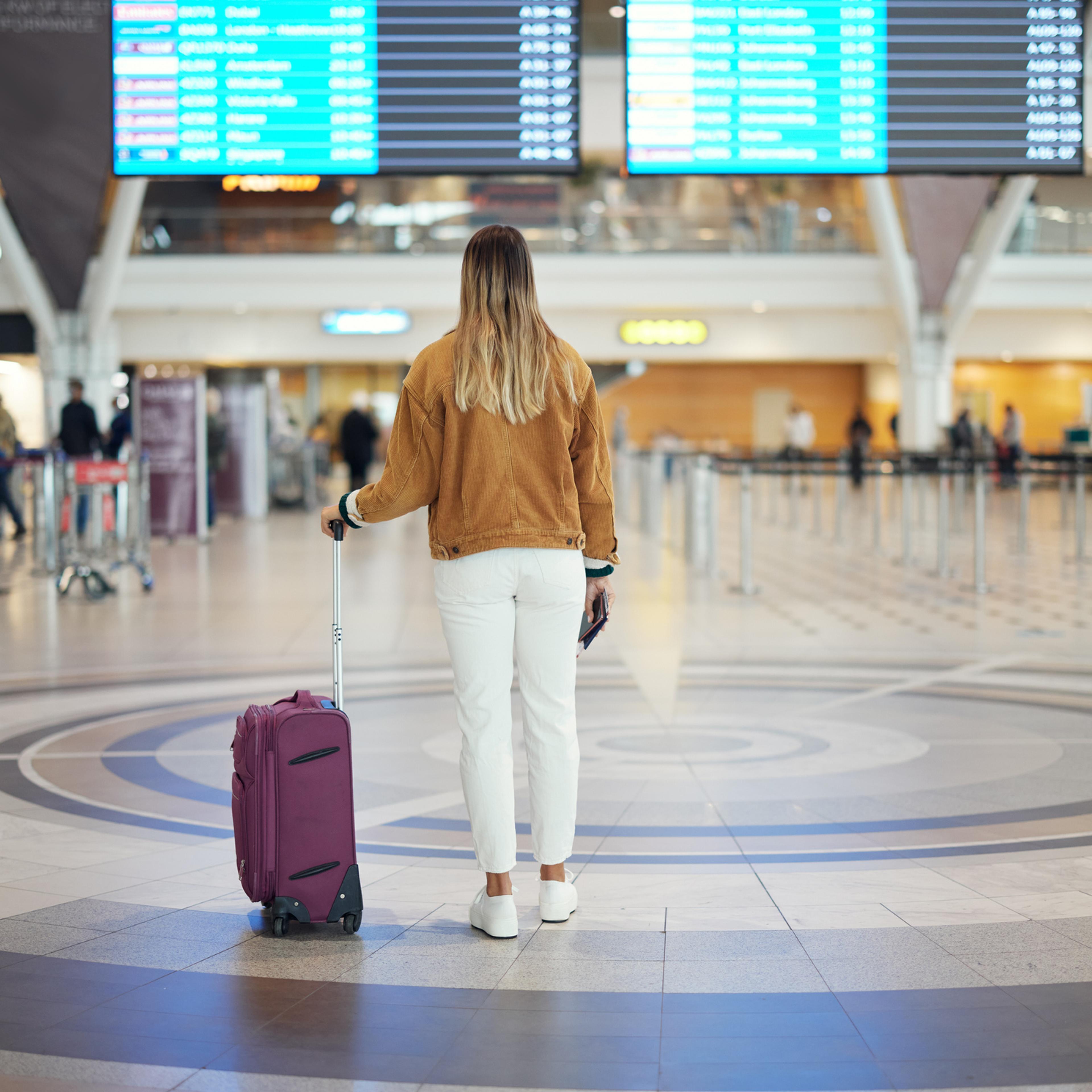 Woman at South Africa's Cape Town Airport with suitcase