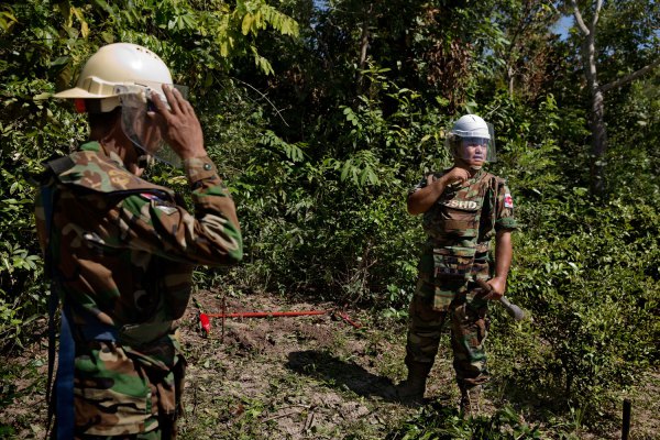 Aki Ra, right, at work with a member of his Cambodian Self Help Demining team in northwestern Cambodia
