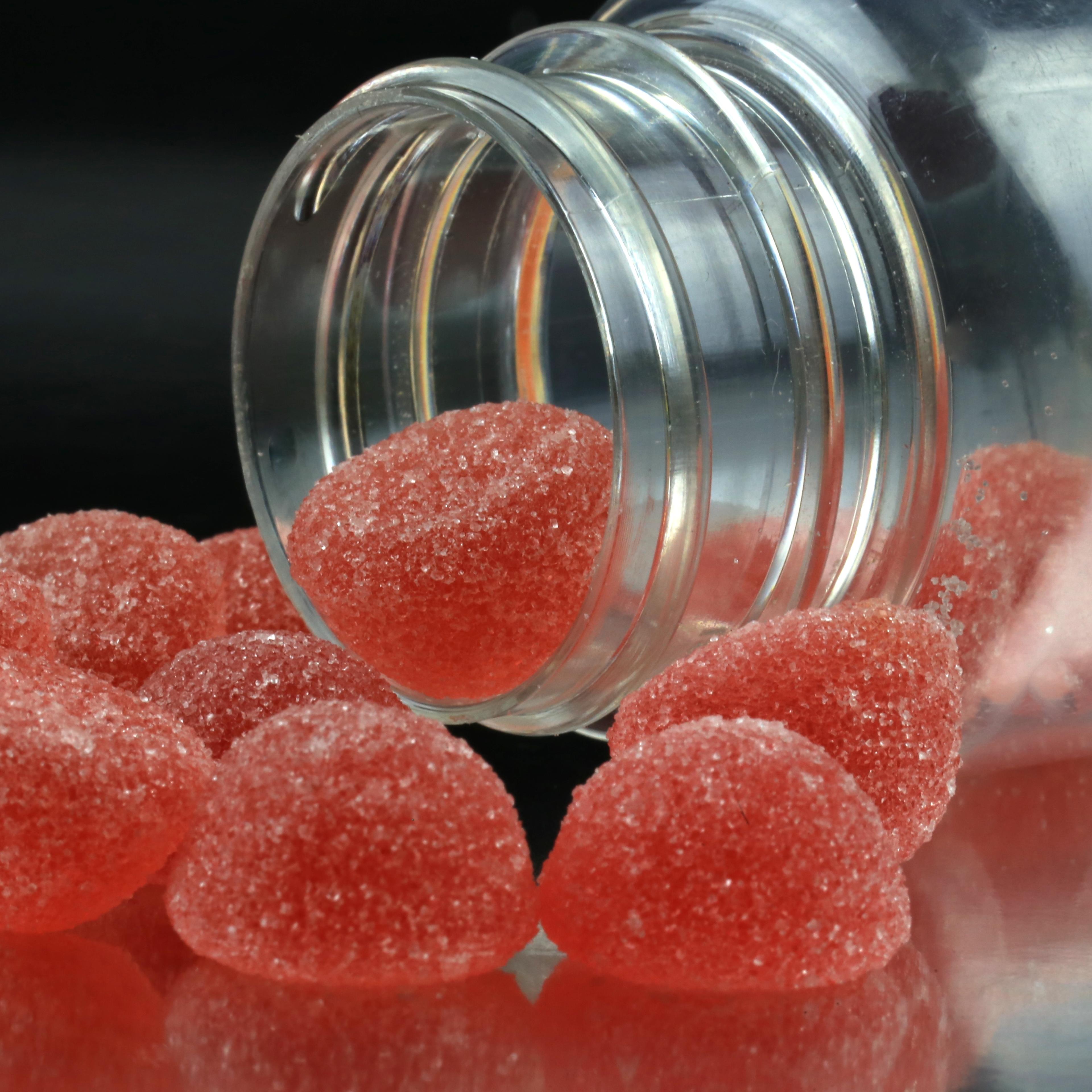 Gummy vitamins spilling out of a bottle