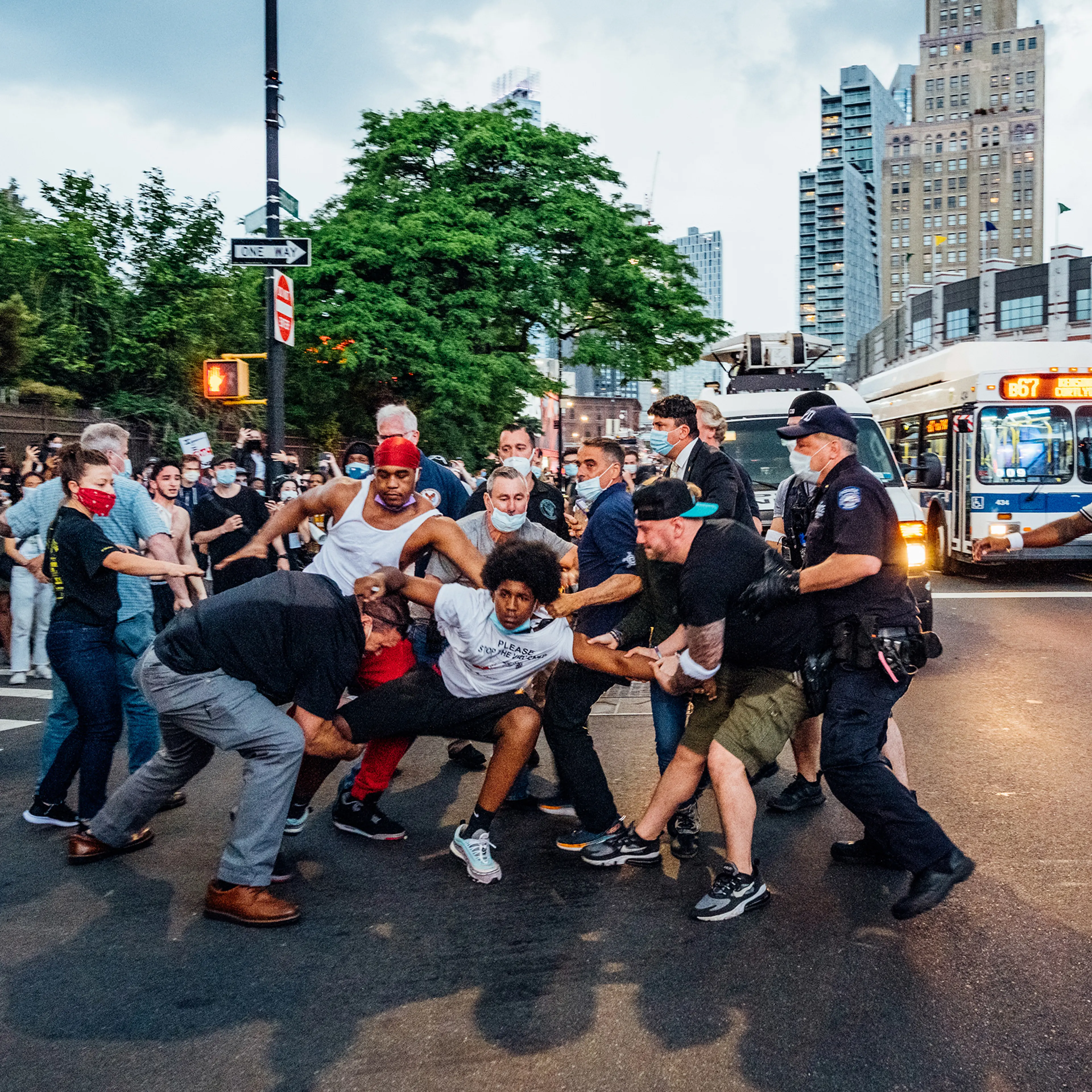 A protester, wearing a shirt that reads "Please Stop the Violence," is dragged near Brooklyn's Barclays Center on May 29, four days after George Floyd's death.