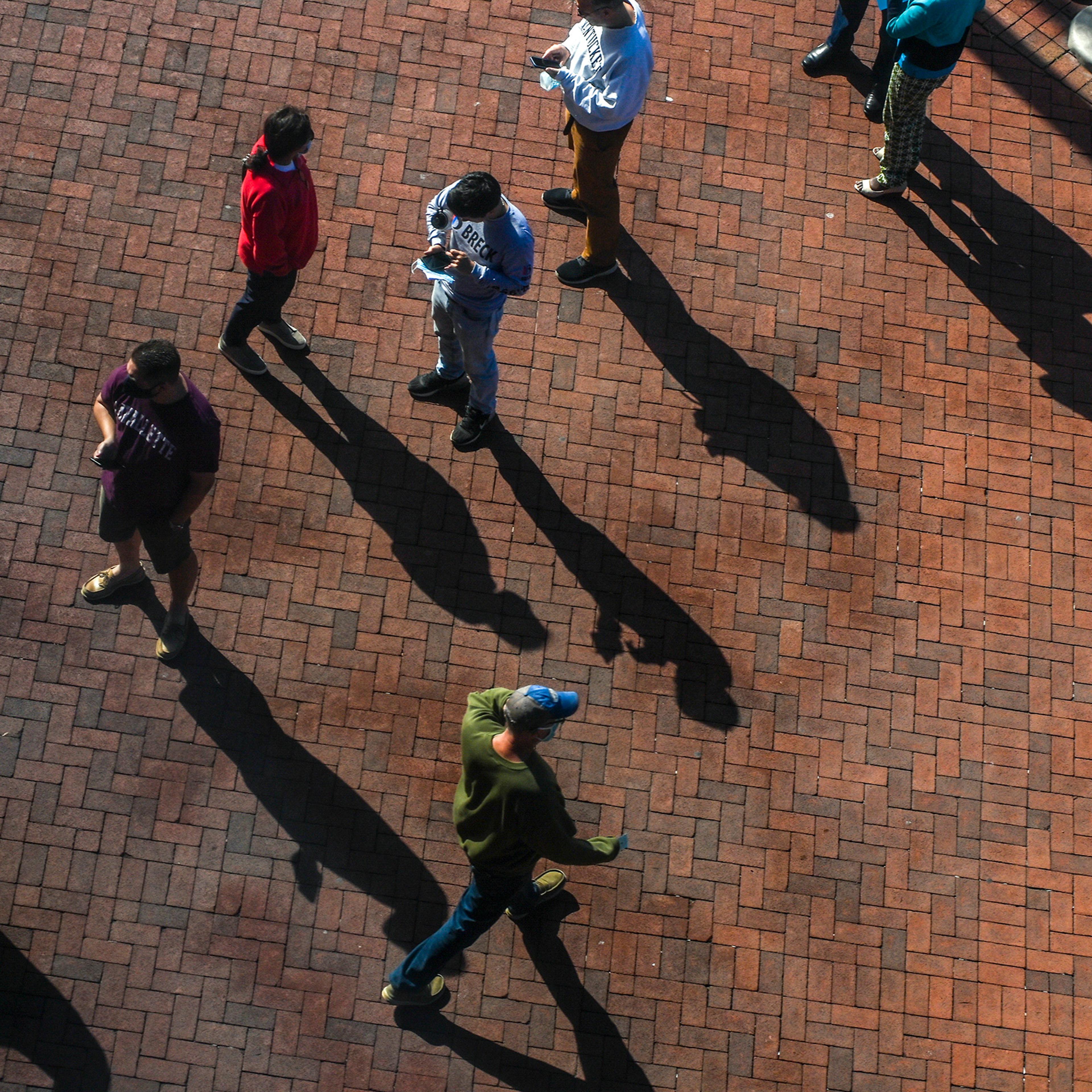 Voters wait in line outside a polling place in Fairfax, Va., on Oct. 23.