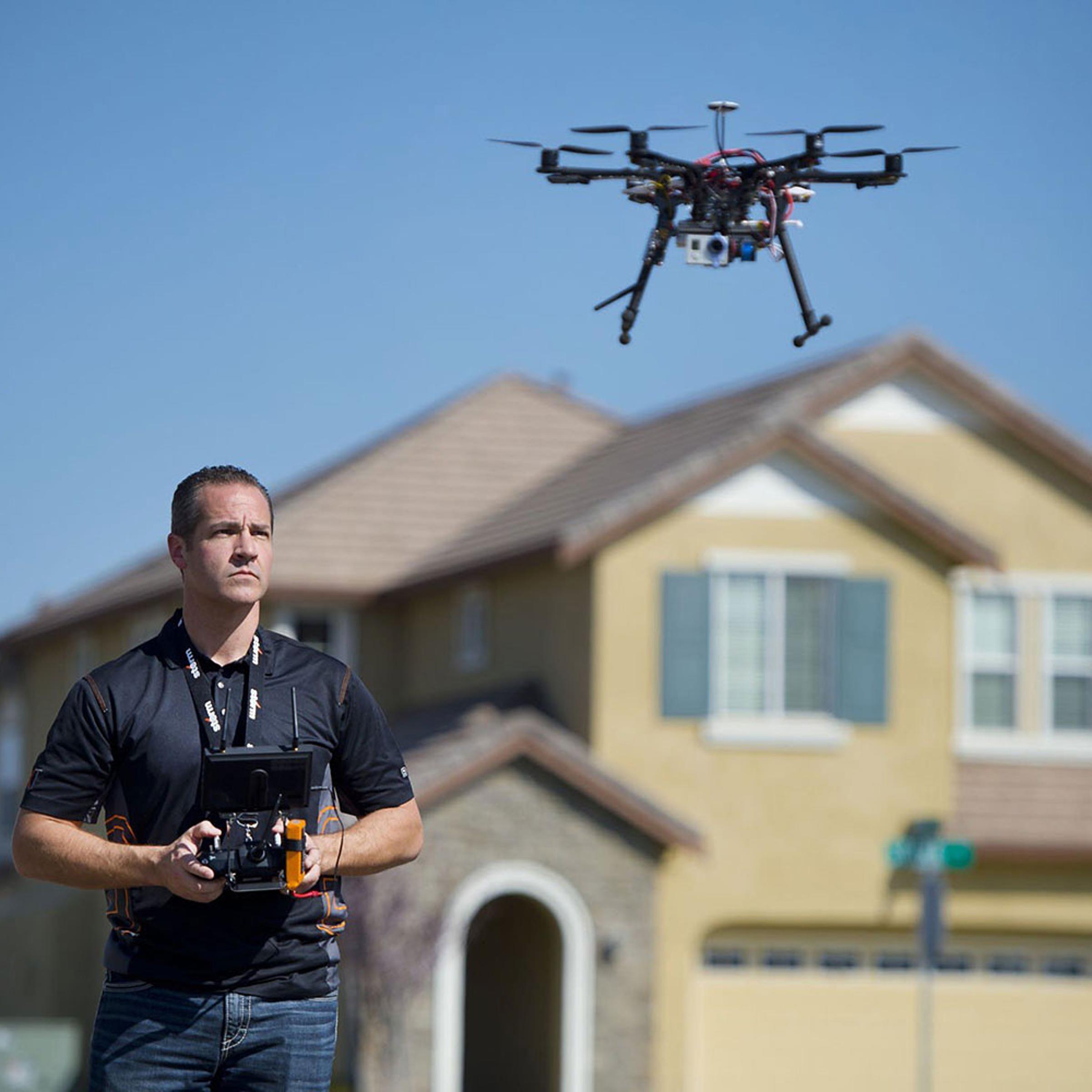 Christopher Brown, co-owner of Next New Homes Group, uses his multi-rotor helicopter drone to take aerial video of a home in Sacramento, Calif., on Feb. 25, 2014.