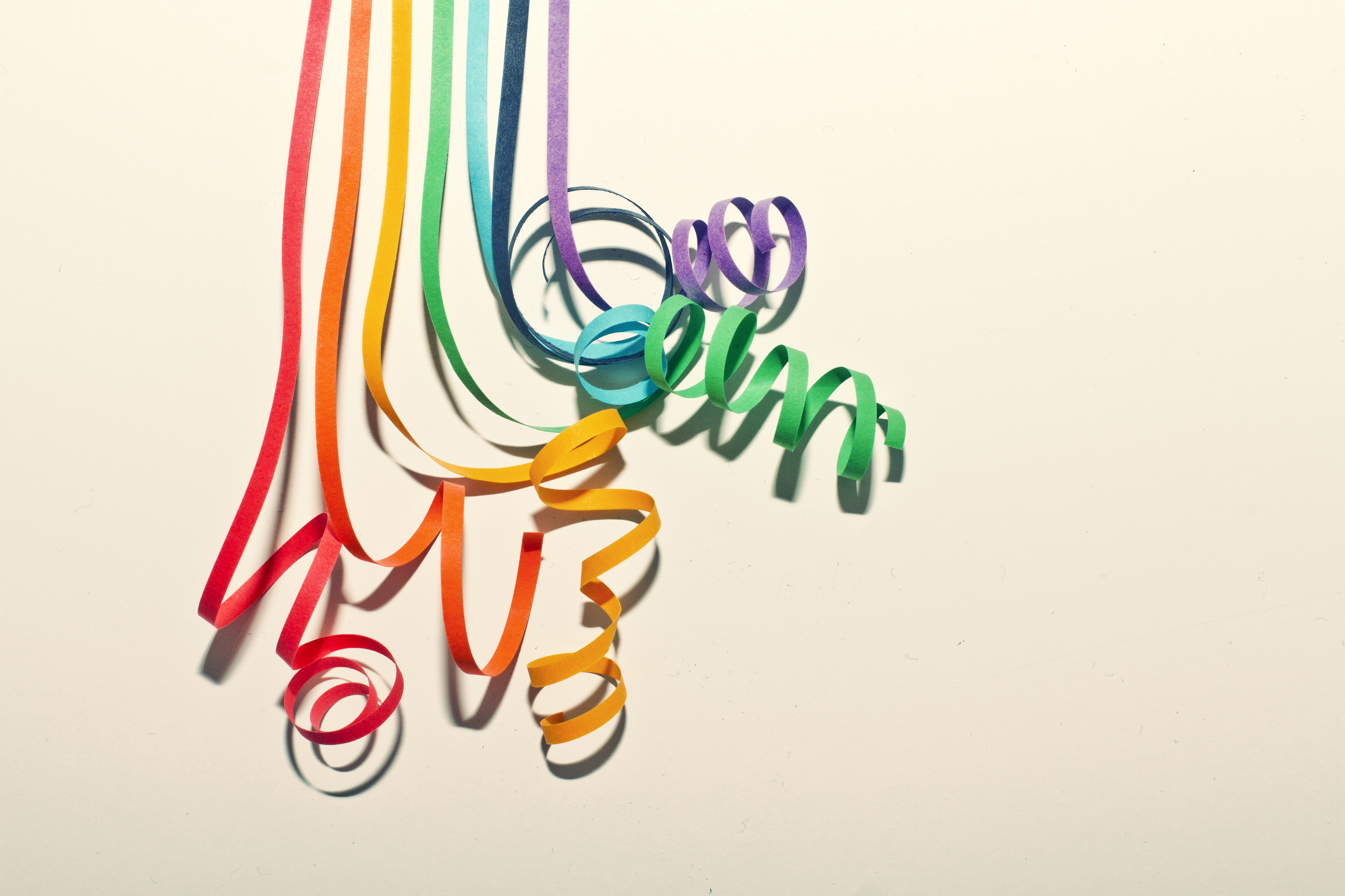 Colorful paper curls on white