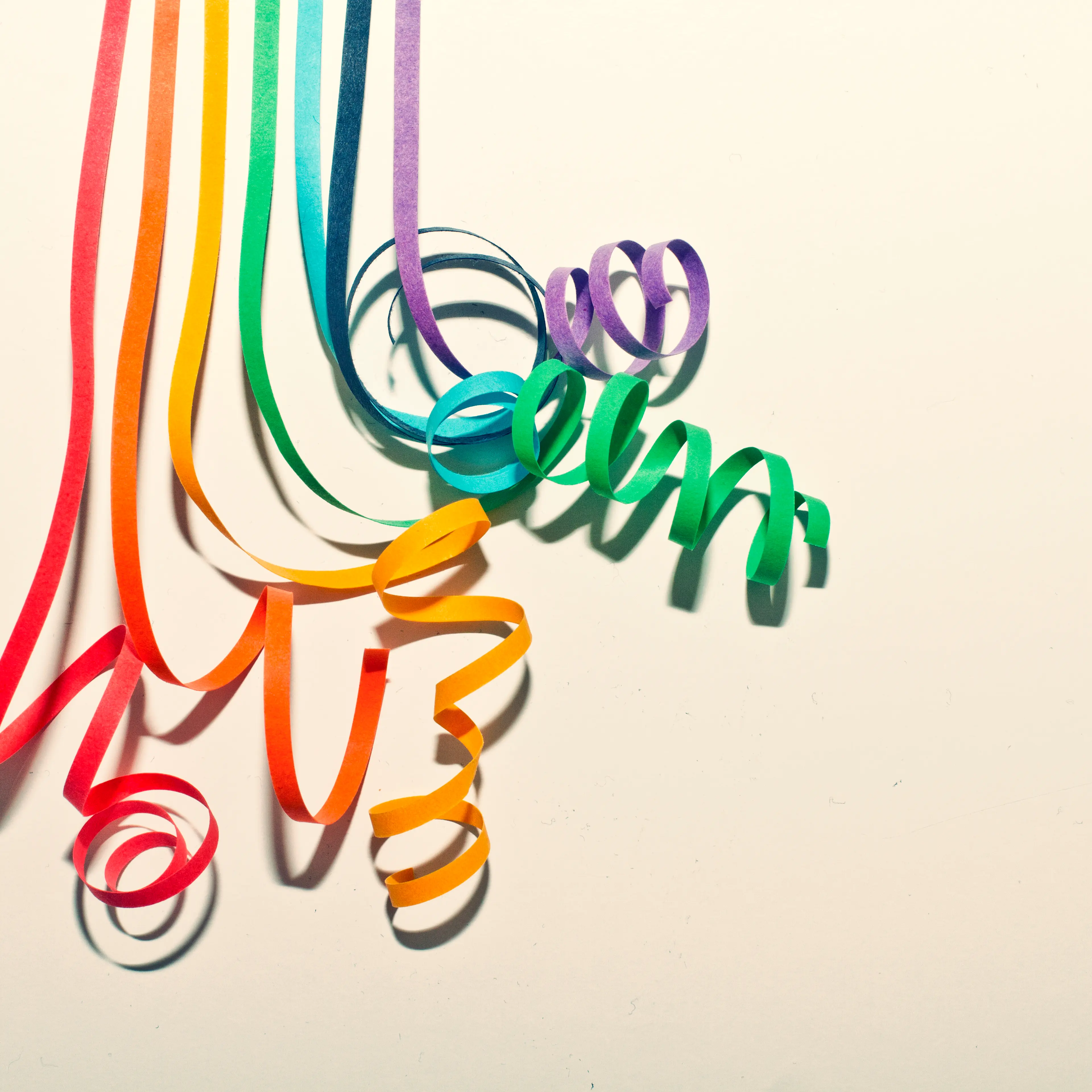 Colorful paper curls on white