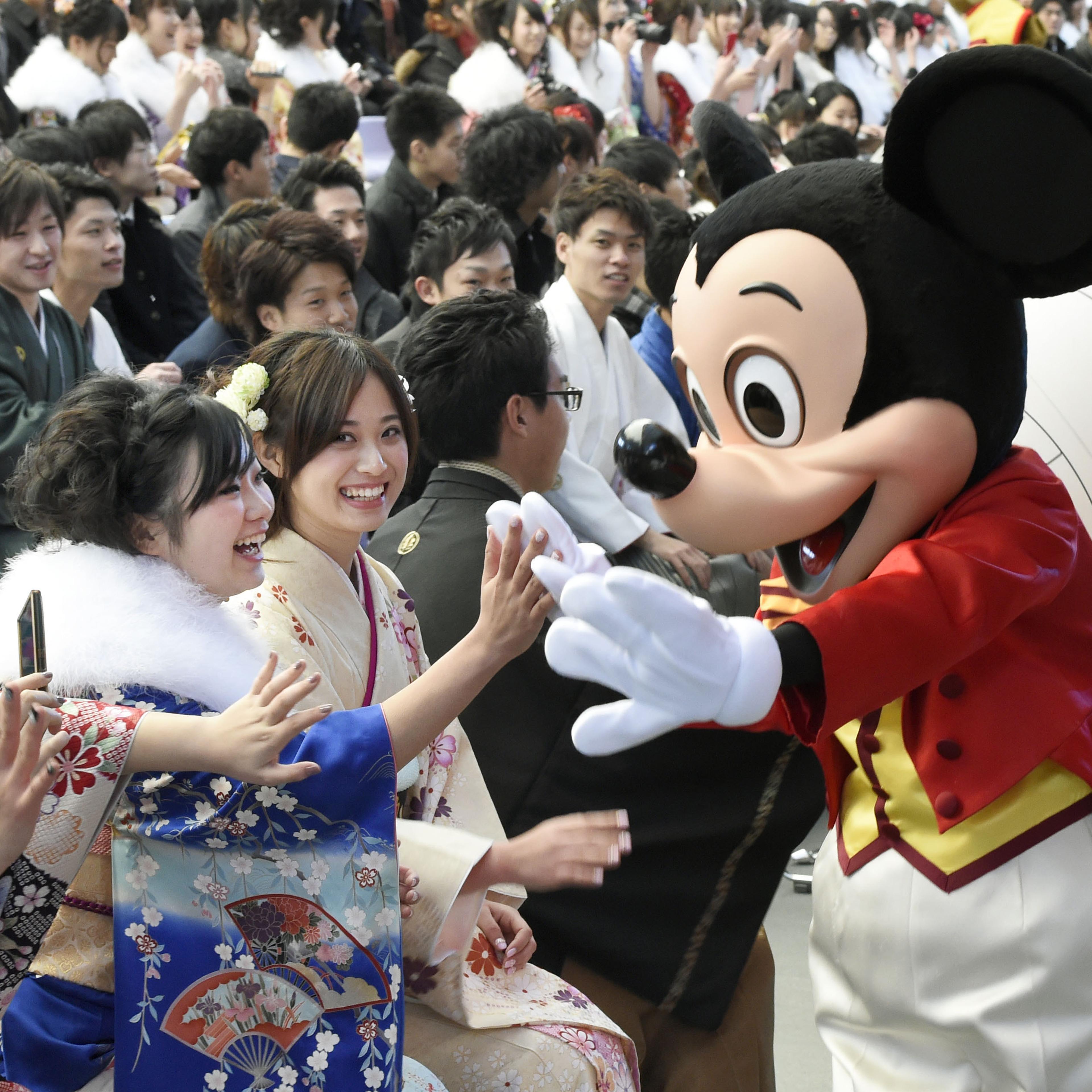 Mickey Mouse congratulates coming-of-age ceremony attendants
