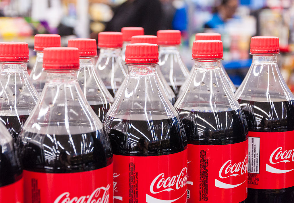 Coke bottles.  Several bottles of Coca Cola classic lined up