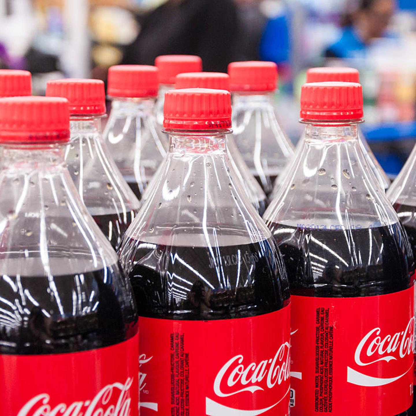 Coke bottles. Several bottles of Coca Cola classic lined up