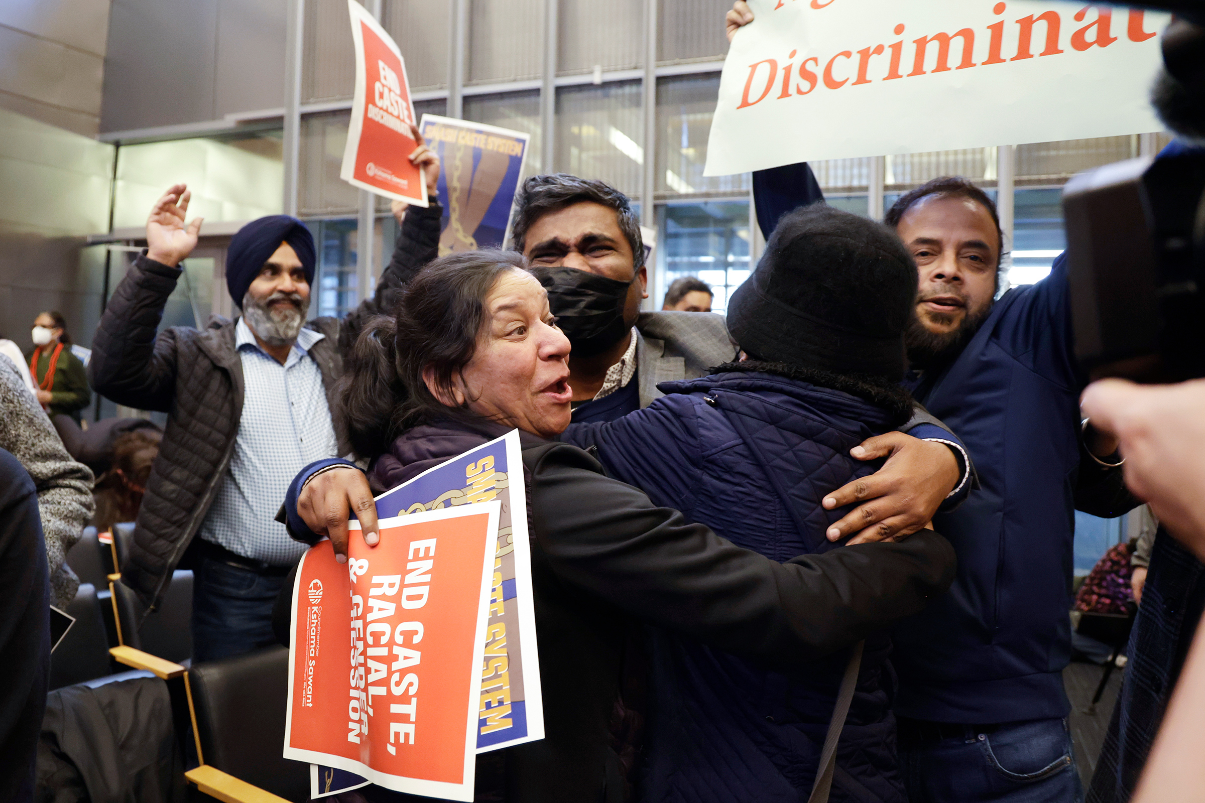 People celebrate the passing of an ordinance to add caste to Seattle's anti-discrimination laws in the Seattle City Council chambers on Feb. 21.