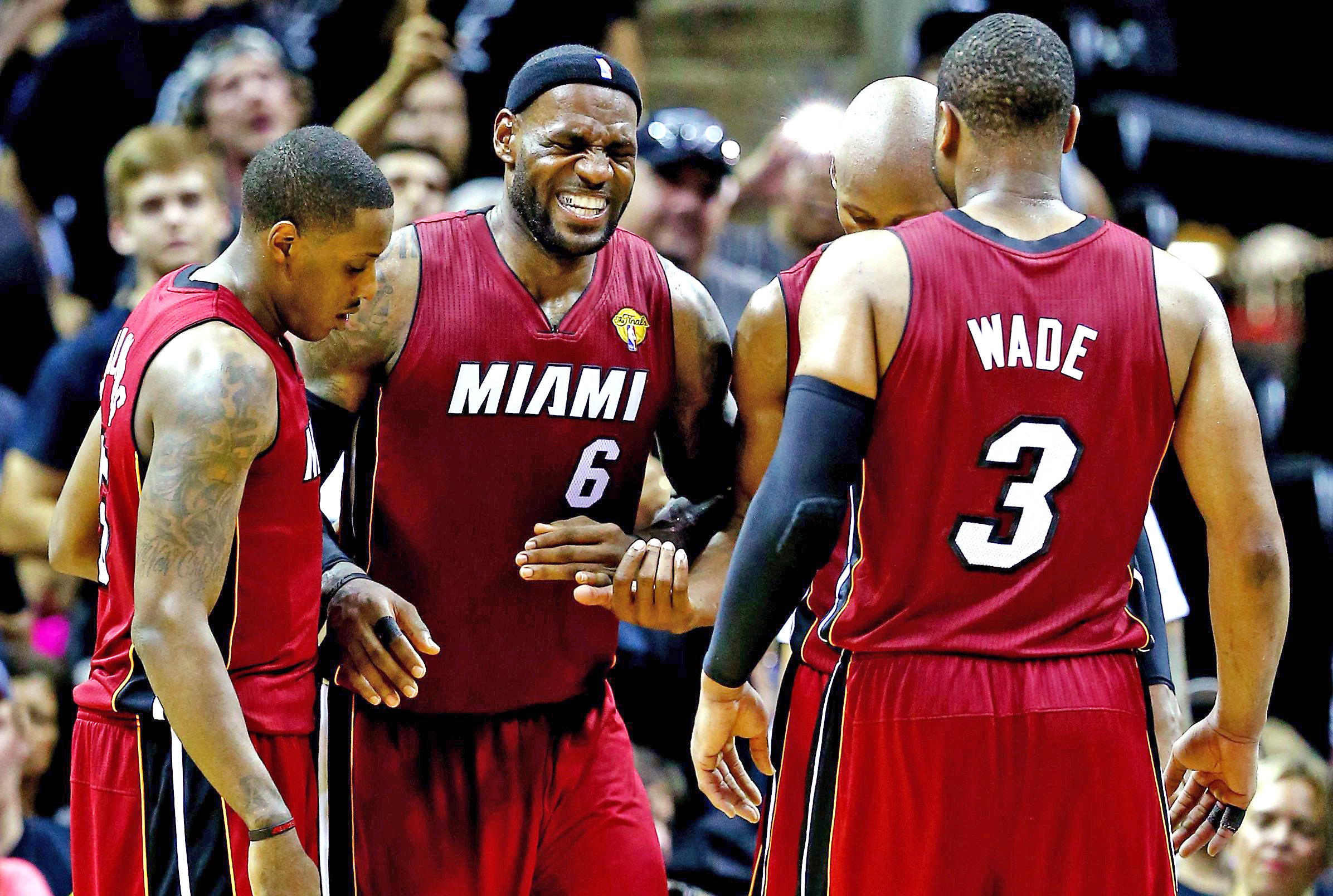 LeBron James #6 of the Miami Heat reacts after cramping up against the San Antonio Spurs during Game One of the 2014 NBA Finals at the AT&T Center on June 5, 2014 in San Antonio.