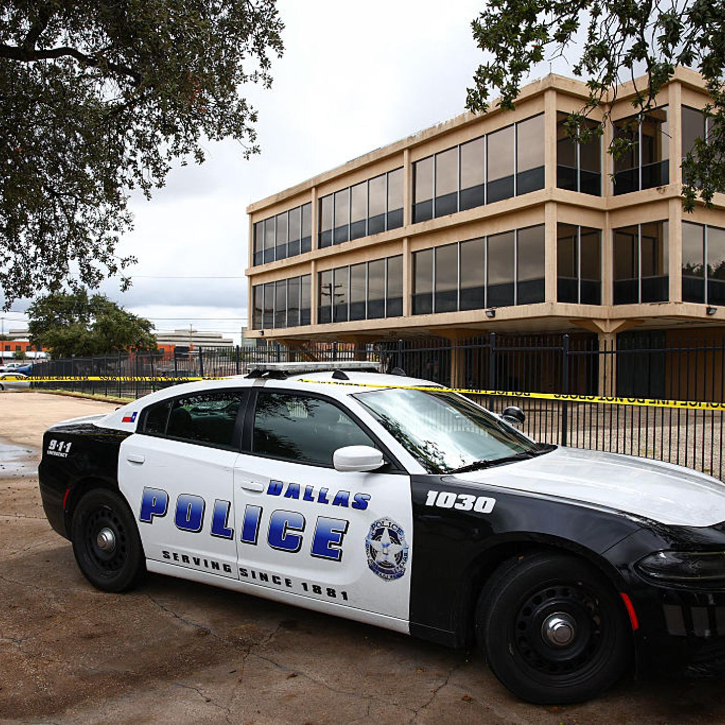 A Dallas Police Department vehicle sits near the scene of a shooting near a US Immigration and Customs Enforcement (ICE) detention facility in Dallas, Texas, on Sept. 24, 2025.