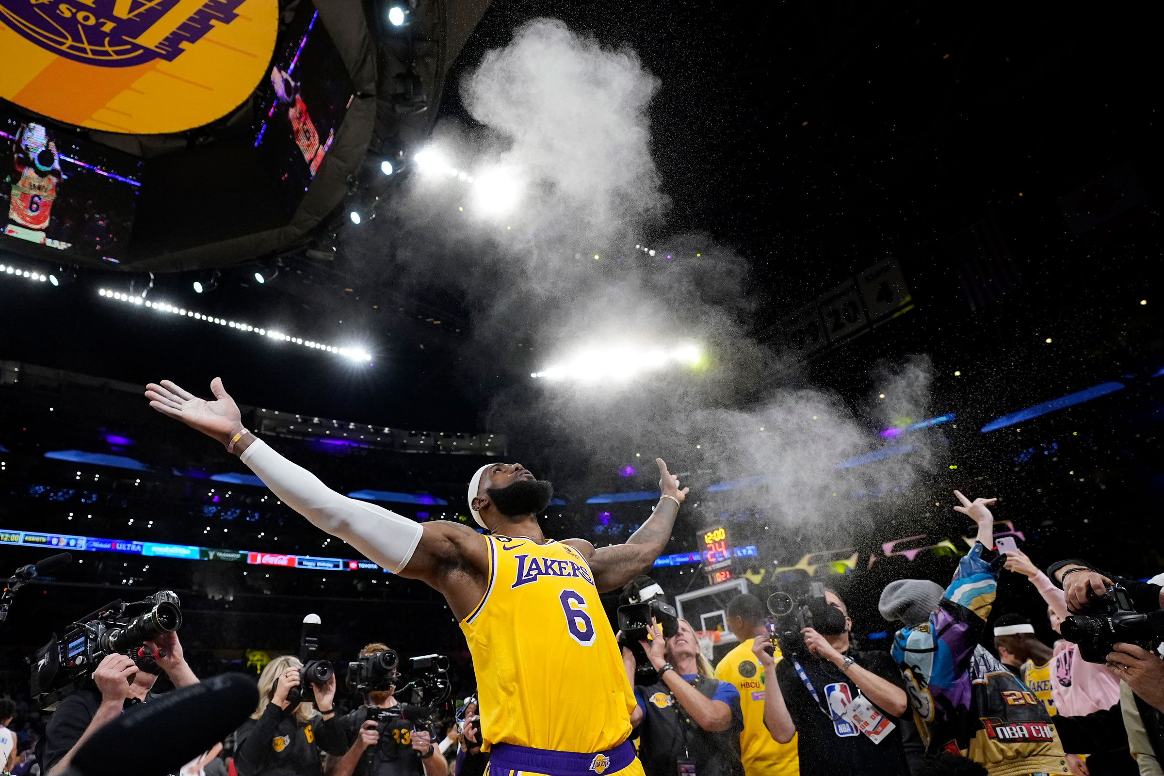 Los Angeles Lakers forward LeBron James tosses powder in the air prior to the team's NBA basketball game against the Oklahoma City Thunder on Tuesday, Feb. 7, 2023