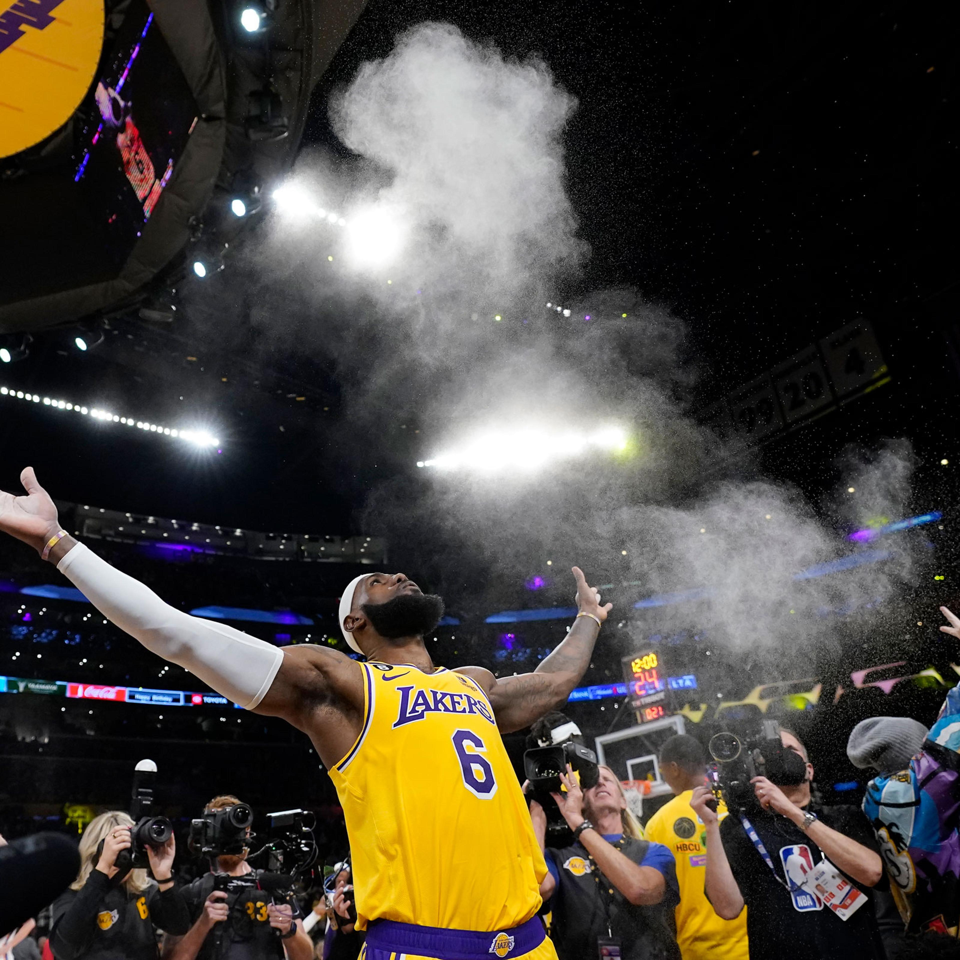 Los Angeles Lakers forward LeBron James tosses powder in the air prior to the team's NBA basketball game against the Oklahoma City Thunder on Tuesday, Feb. 7, 2023