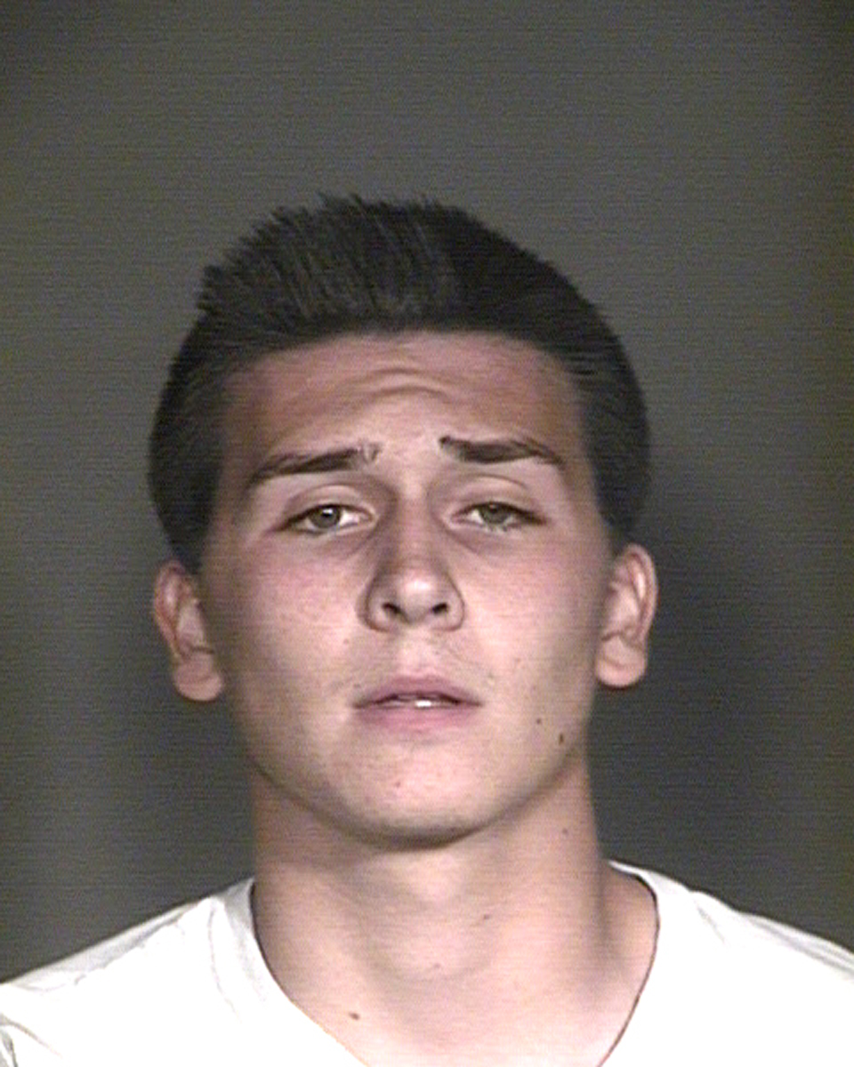 This undated booking photo provided by the Mesa Police Department, in Mesa, Ariz., shows Hunter Osborn. The Arizona high school student is facing dozens of charges after police say he exposed himself in a football team picture that ended up in a yearbook