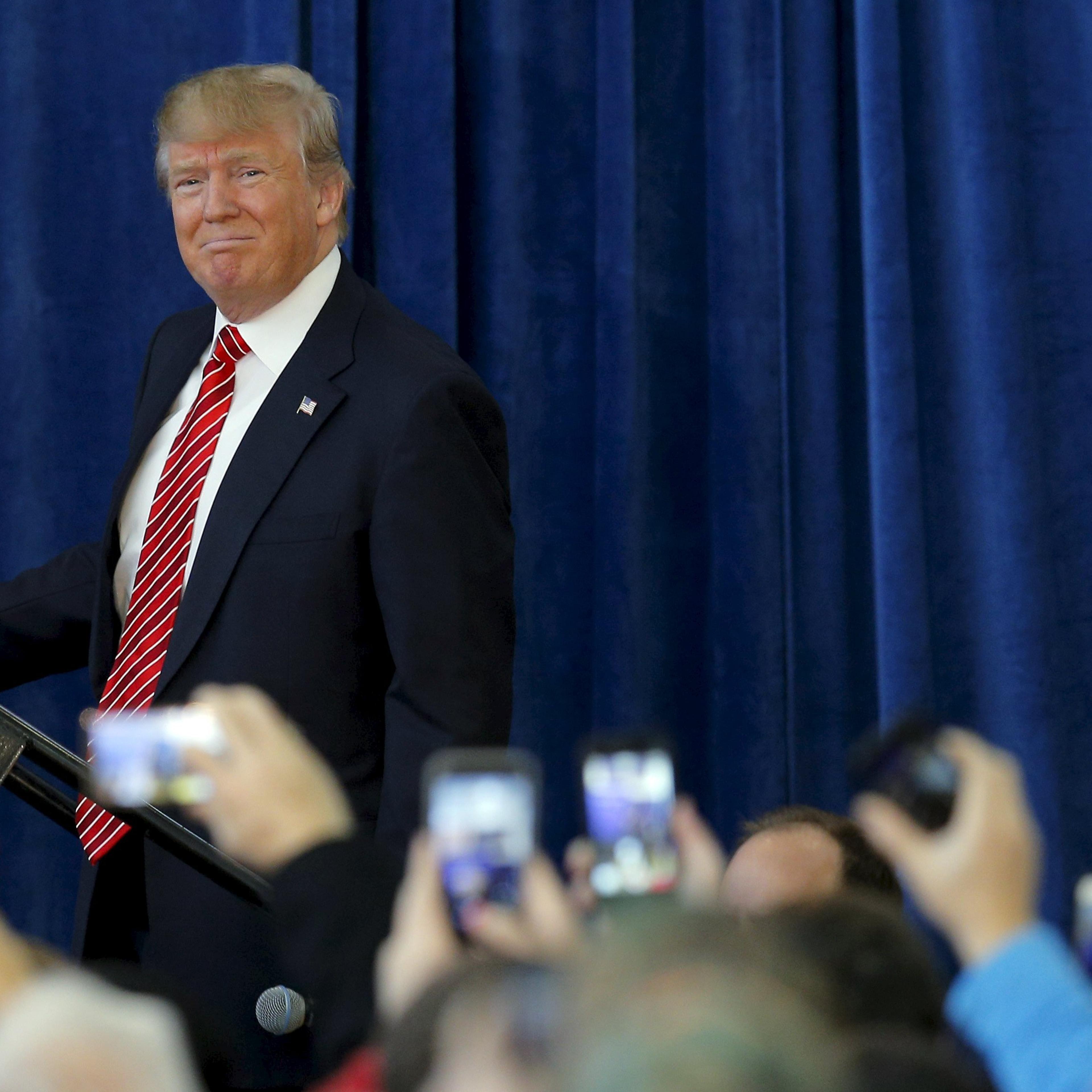 U.S. Republican presidential candidate Donald Trump takes the stage at a campaign rally in Portsmouth