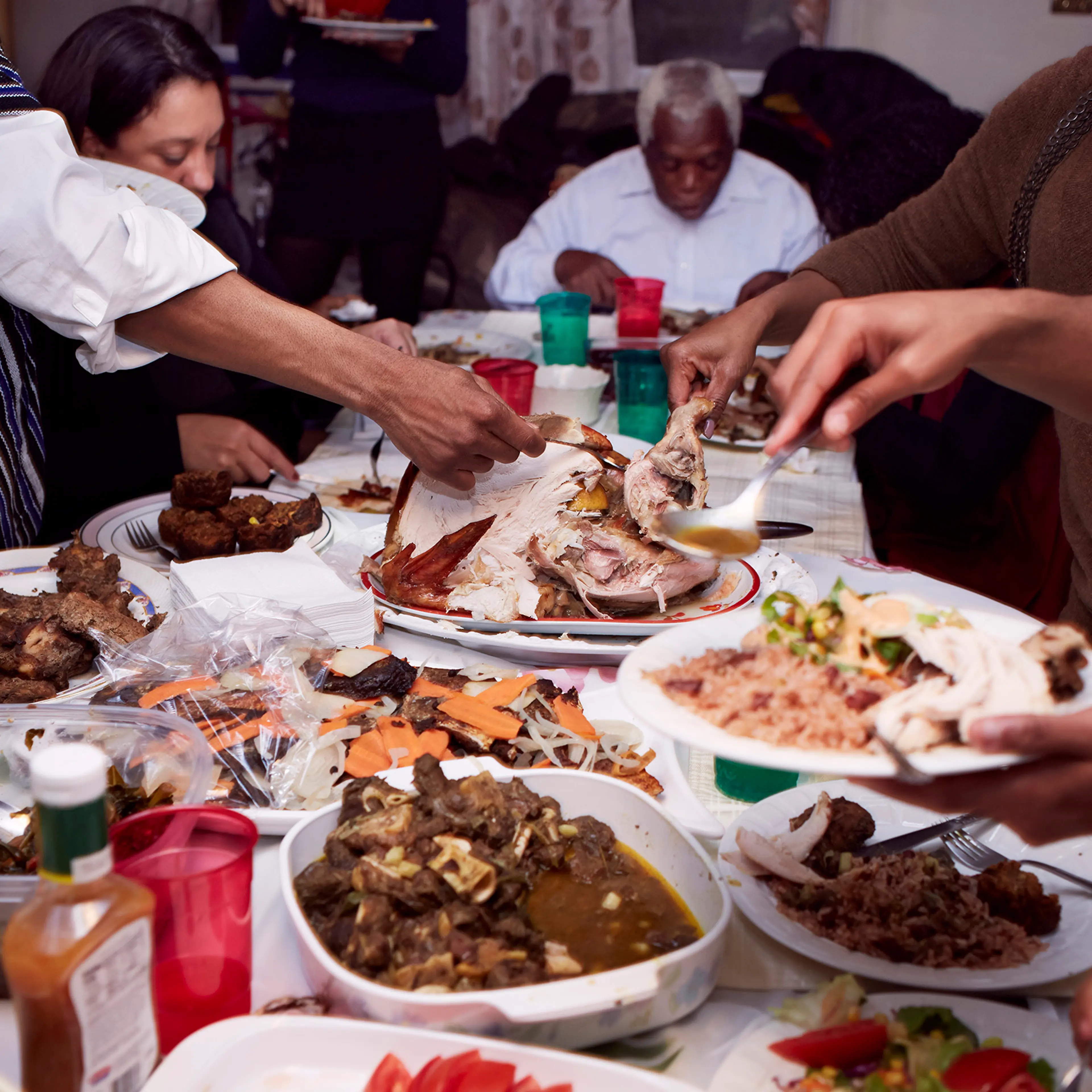 Family serving food at holiday dinner