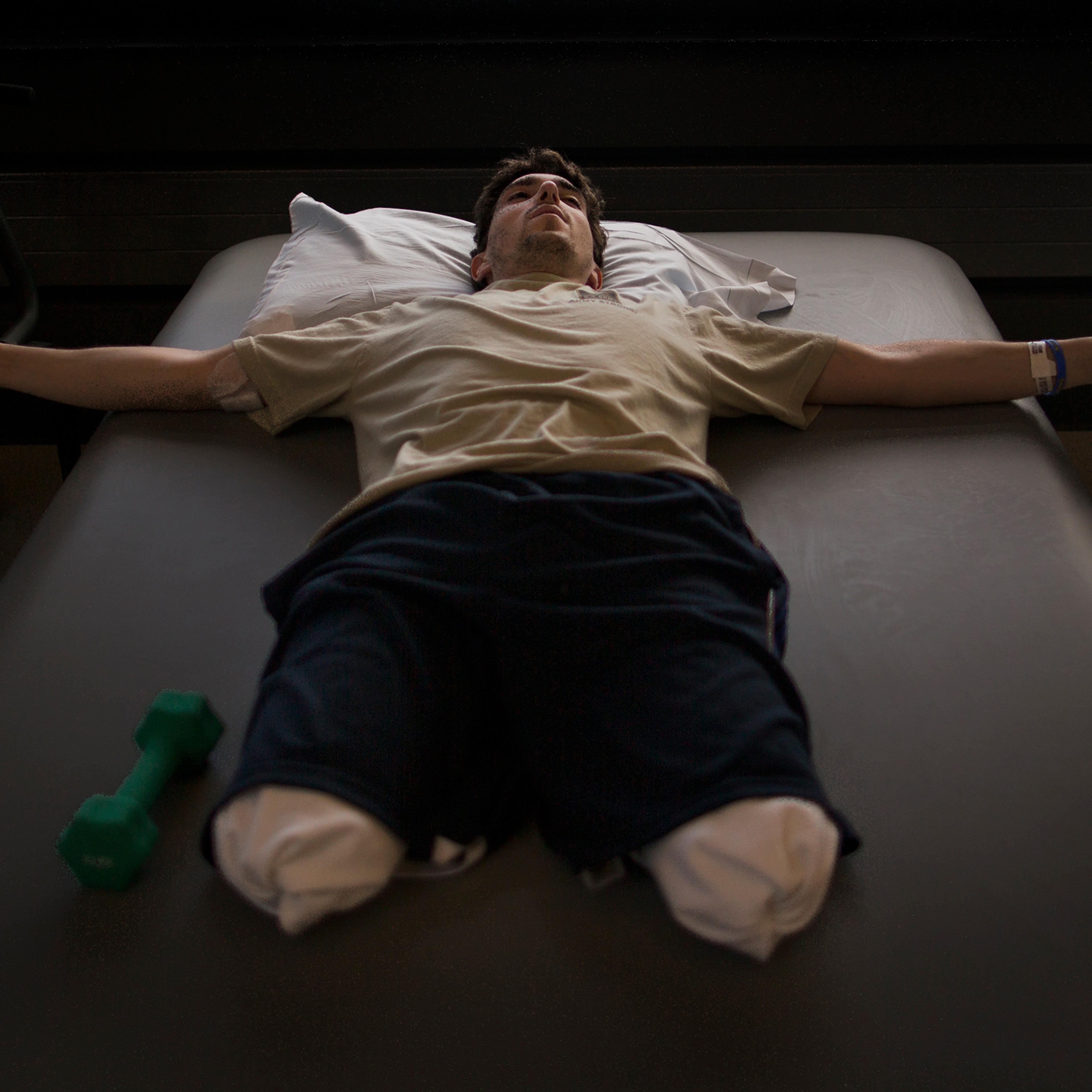 Jeff Bauman, who lost his lower legs in the Boston Marathon bombings, rests between occupational therapy sessions at Spaulding Rehabilitation Hospital in Boston, May 8, 2013.