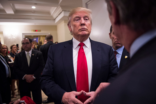 Republican presidential candidate Donald Trump stops to talk to a reporters as he makes his way through he crowd after speaking during a campaign press conference event at the Trump National Golf Club in Jupiter, FL on Tuesday March 08, 2016.