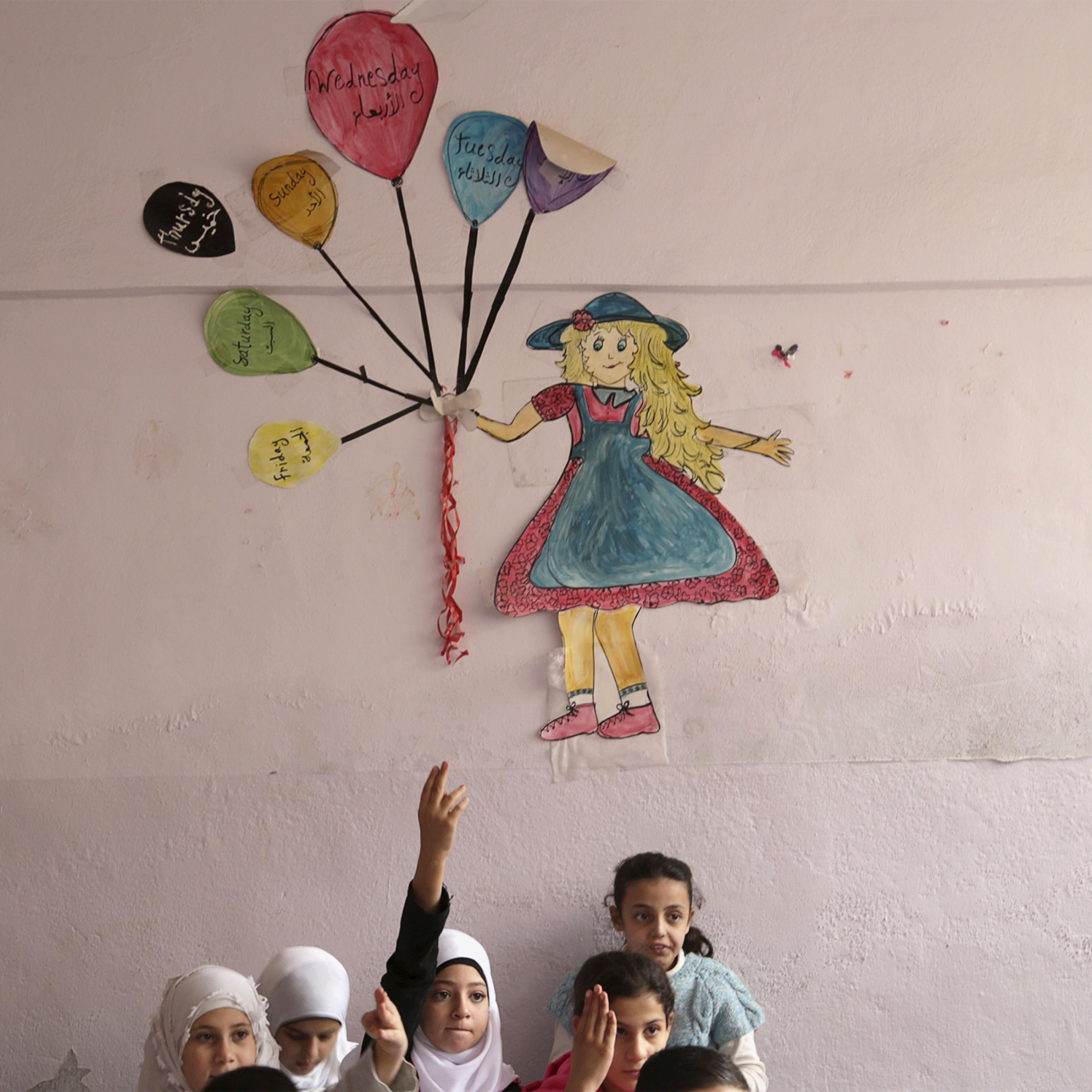 Students attend a class inside Hosam Kamel school in the rebel-controlled area of Maaret al-Numan town in Idlib province, Syria on October 28, 2015. The school, which was bombed and partially destroyed, started the new school year after restoration work was completed, activists said.