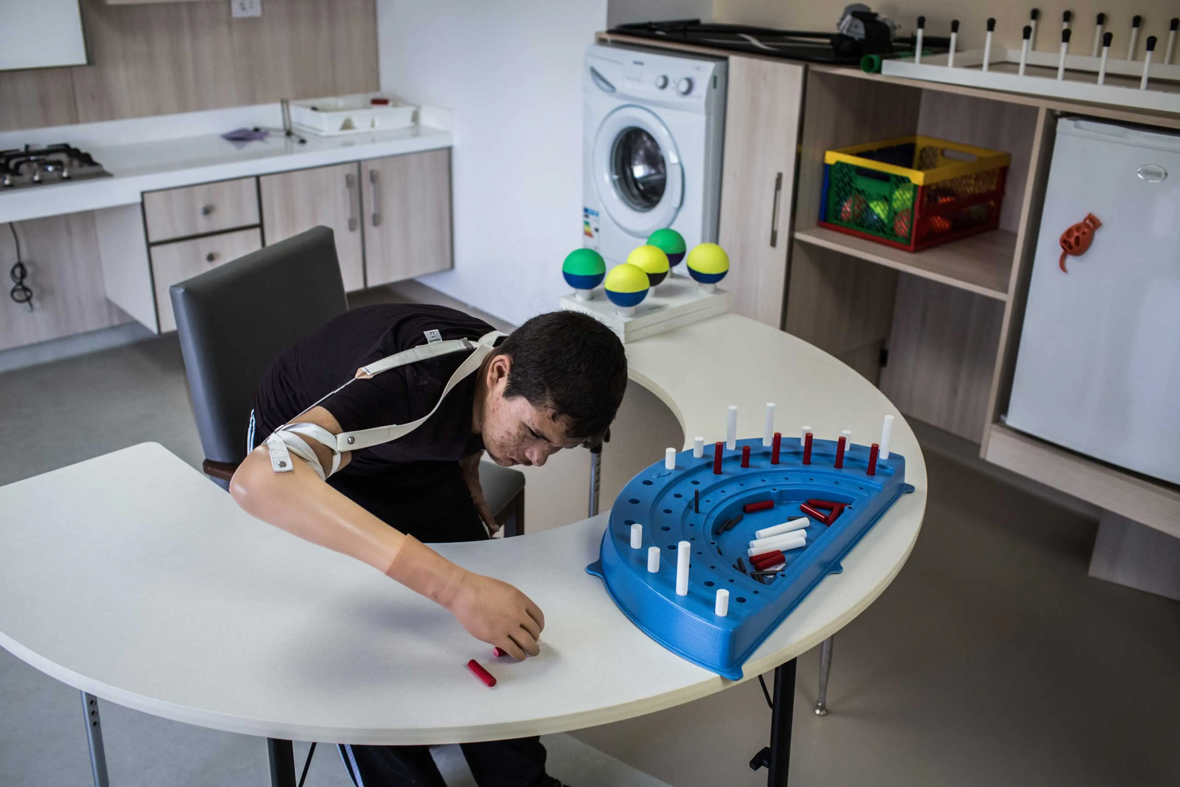 Nawaf, 15, learns to use a prosthetic right arm in Tripoli, Lebanon, June 18, 2014. He was severely burned after a bomb hit his home in Syria nearly a year ago. Now he is learning a range of movements and becoming more self-reliant.
